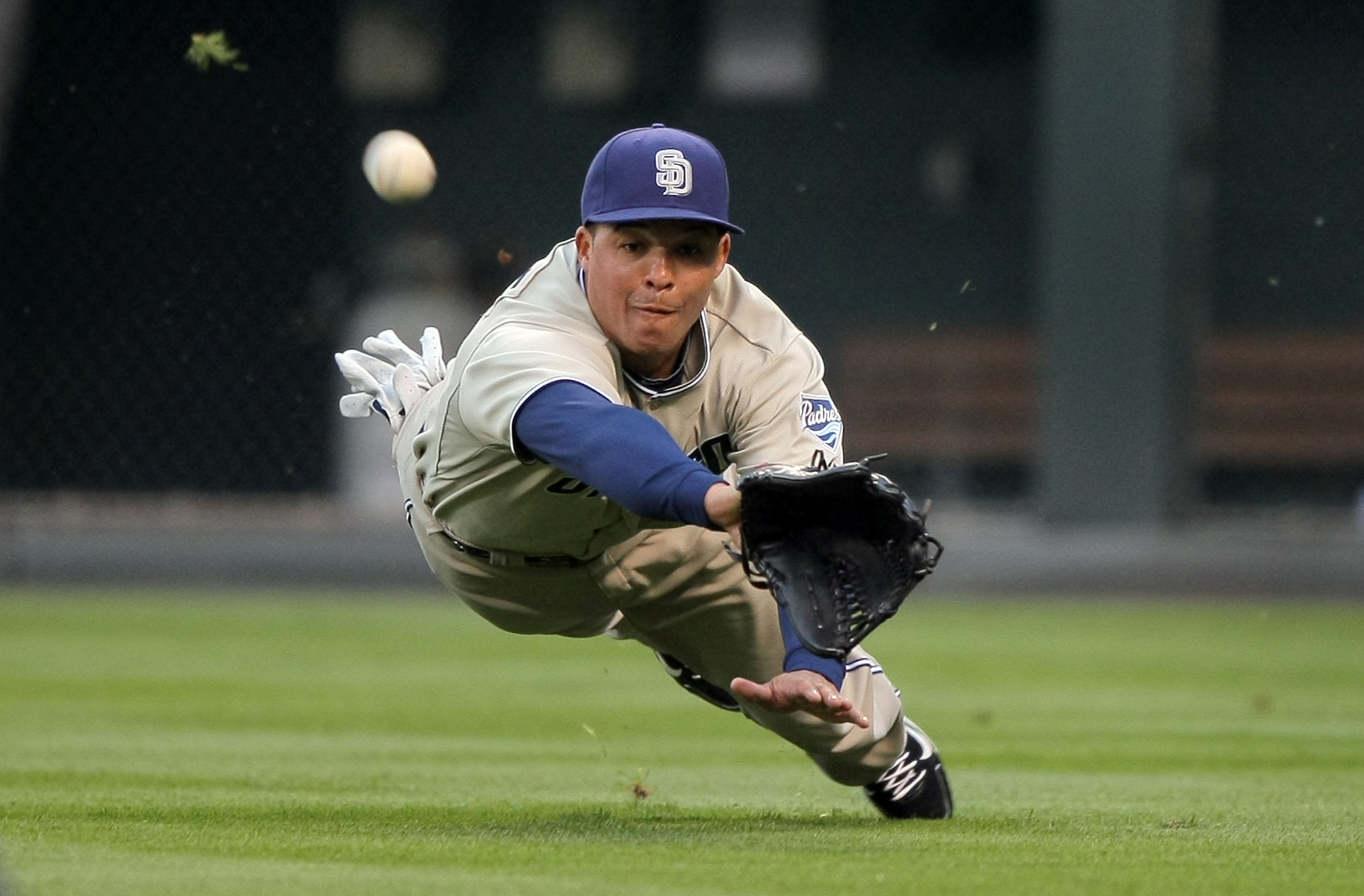 DENVER - APRIL 10:  Rightfielder Will Venable #25 of the San Diego Padres dives buts is unable to make a catch on a soft linedrive by Clint Barmes of the Colorado Rockies in the third inning during MLB action at Coors Field on April 10, 2010 in Denver, Co