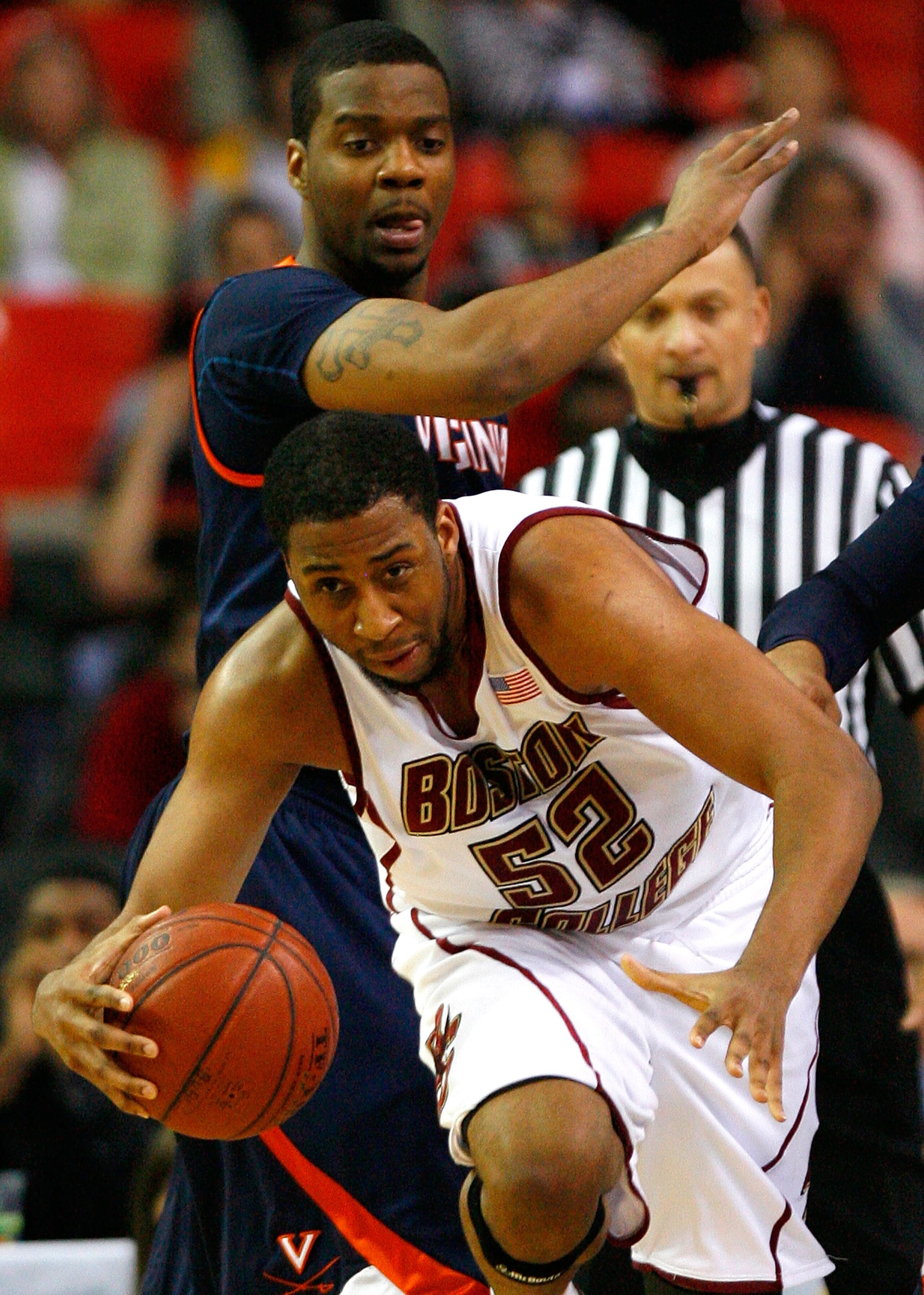 ATLANTA - MARCH 12:  Josh Southern #52 of the Boston College Eagles grabs a rebound against Jamil Tucker #12 of the Virginia Cavaliers during day one of the 2009 ACC Men's Basketball Tournament on March 12, 2009 at the Georgia Dome in Atlanta, Georgia.  (