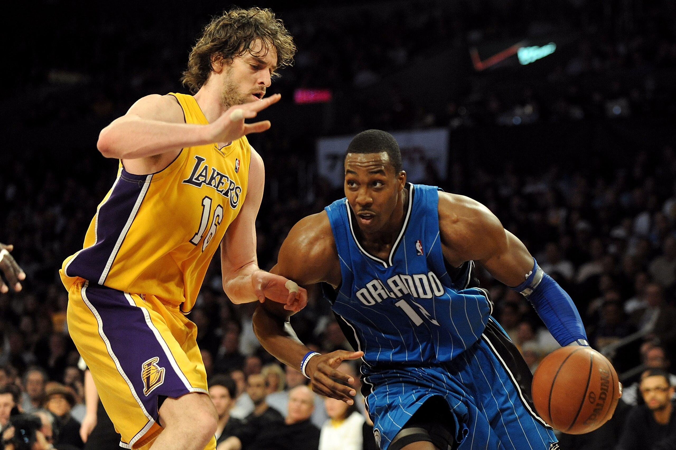 LOS ANGELES, CA - JANUARY 18:  Dwight Howard #12 of the Orlando Magic drives against Pau Gasol #16 of the Los Angeles Lakers in the fourth quarter during the game on January 18, 2010 at Staples Center in Los Angeles, California. The Lakers won 98-92. NOTE