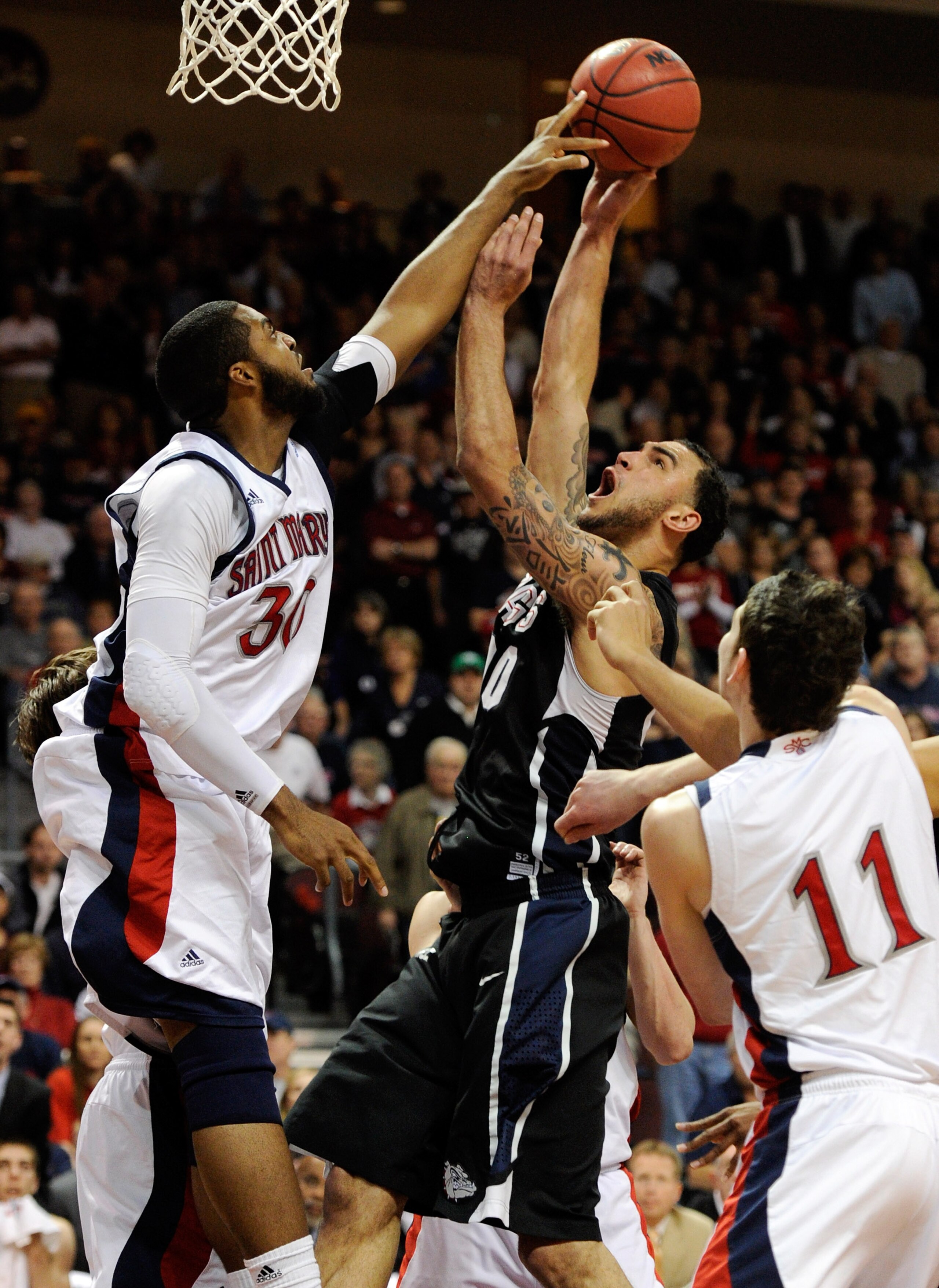 LAS VEGAS, NV - MARCH 07:  Kenton Walker II #30 of the Saint Mary's Gaels blocks a shot by Robert Sacre #00 of the Gonzaga Bulldogs during the championship game of the Zappos.com West Coast Conference Basketball tournament at the Orleans Arena March 7, 20
