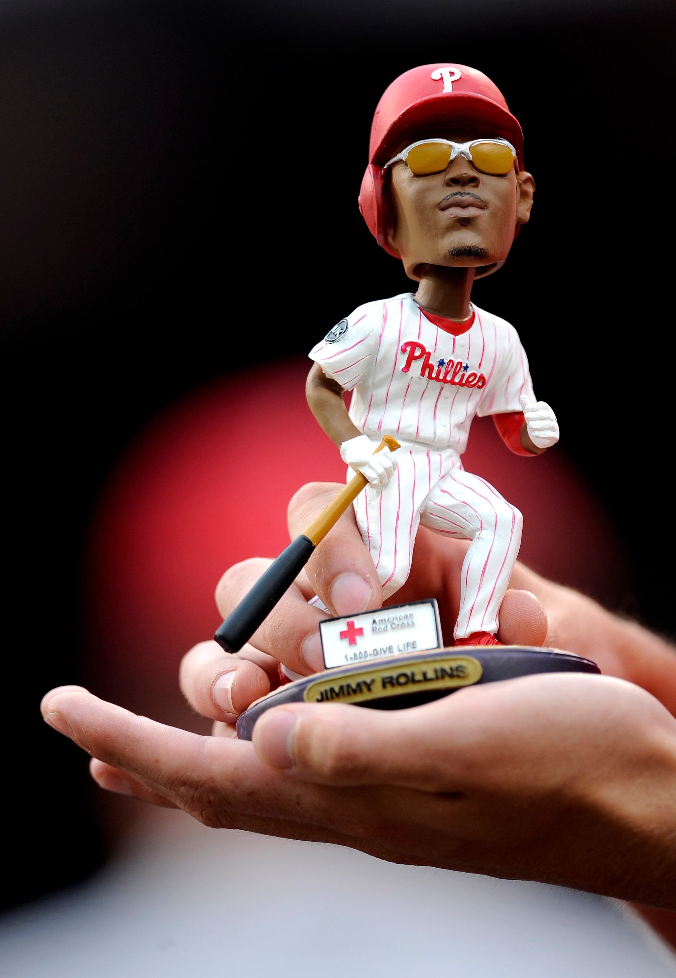 PHILADELPHIA - JUNE 4: A fan holds a bobblehead figure of Jimmy Rollins #11 of the Philadelphia Phillies before a game against the Cincinnati Reds at Citizens Bank Park June 4, 2008 in Philadelphia, Pennsylvania. (Photo by Jeff Zelevansky/Getty Images)