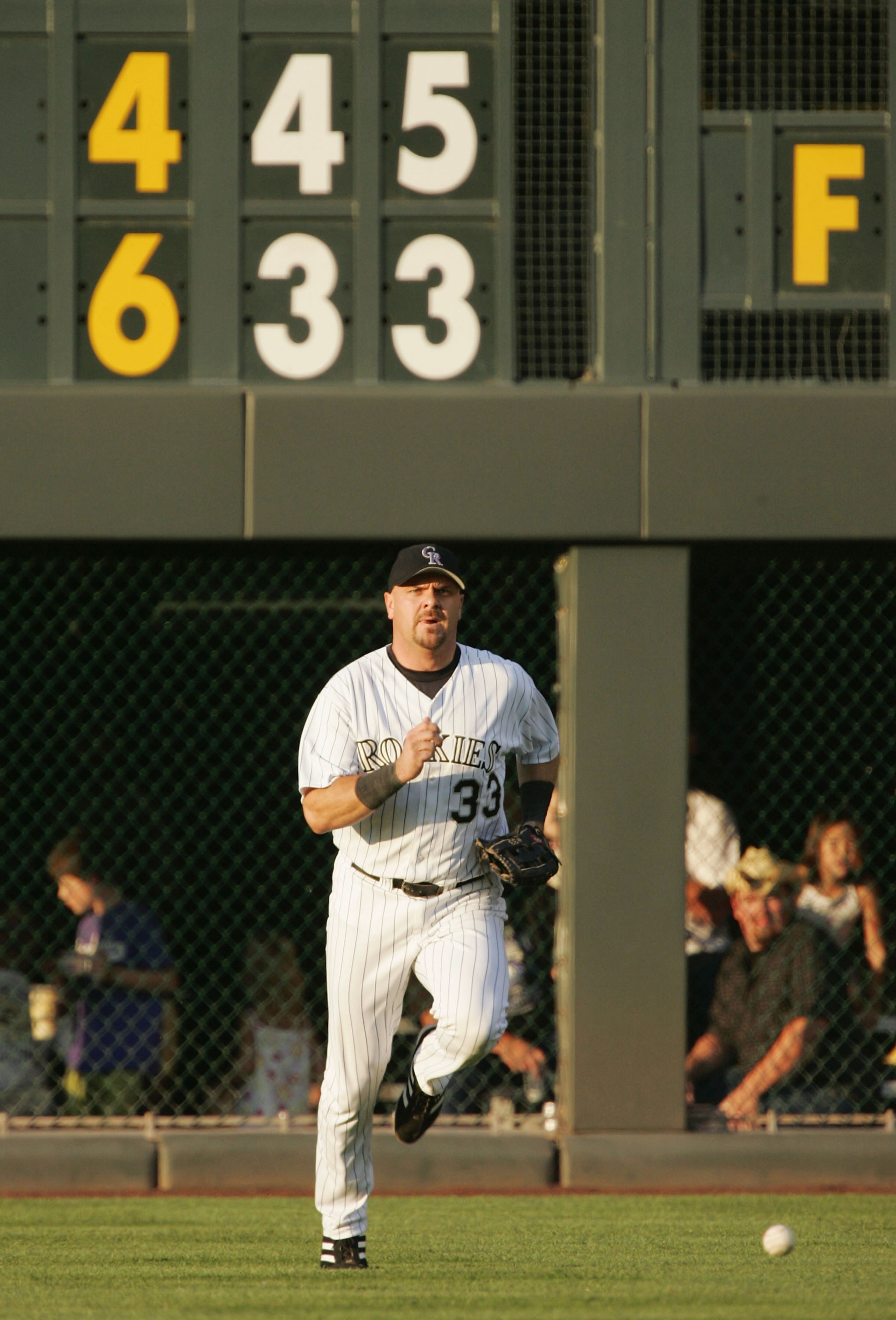 DENVER - JULY 31:  Larry Walker #33 of the Colorado Rockies chases down the ball as he plays it off the wall against the Arizona Diamondbacks in the fourth inning on July 31, 2004 at Coors Field in Denver, Colorado.  (Photo by Brian Bahr/Getty Images)