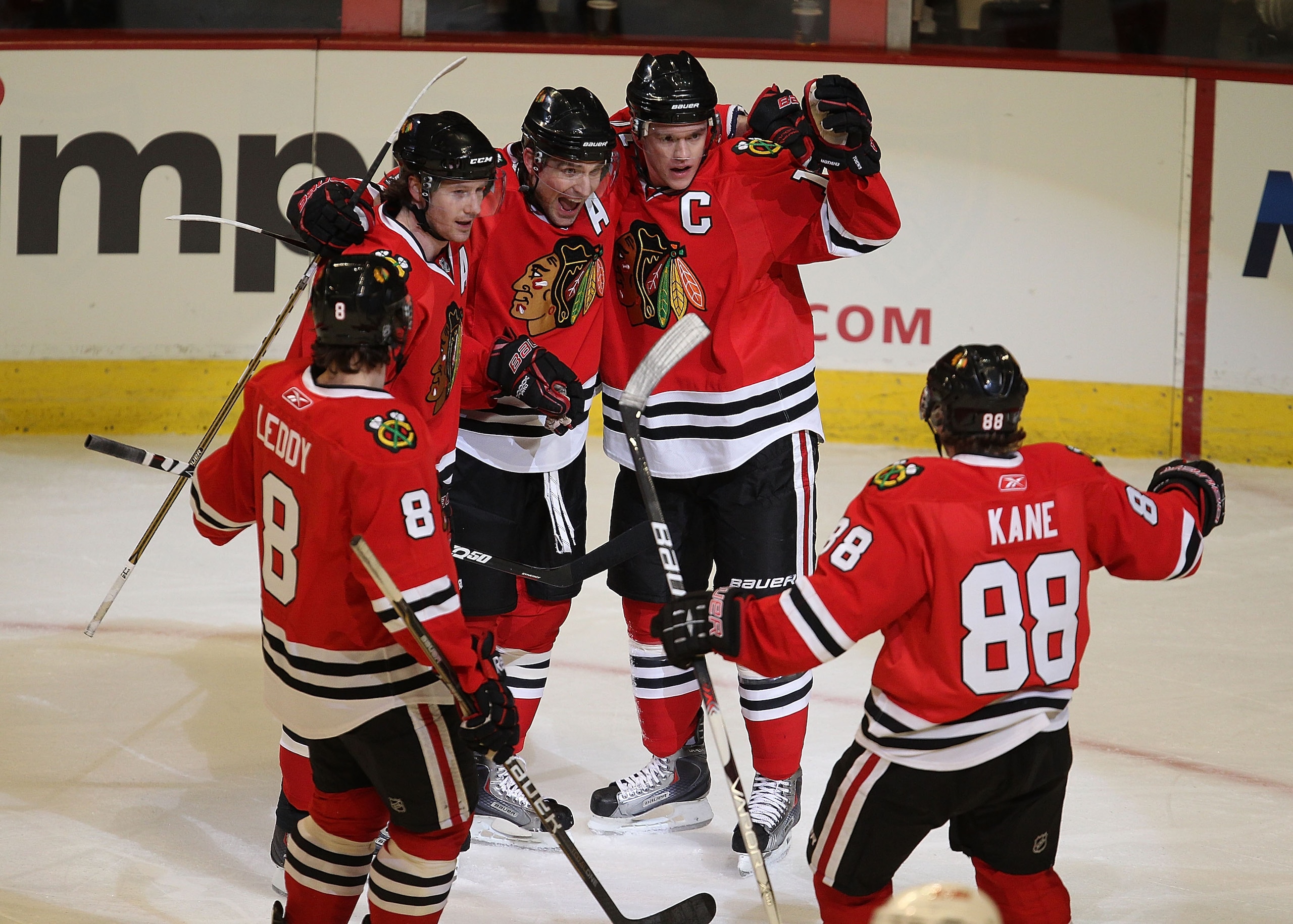 CHICAGO, IL - MARCH 02: (L-R) Nick Leddy #8, Duncan Keith #2, Patrick Sharp #10 and Jonathan Toews #19 of the Chicago Blackhawks welcome teammate Patrick Kane #88 to celebrate Toew's goal against the Calgary Flames at the United Center on March 2, 2011 in