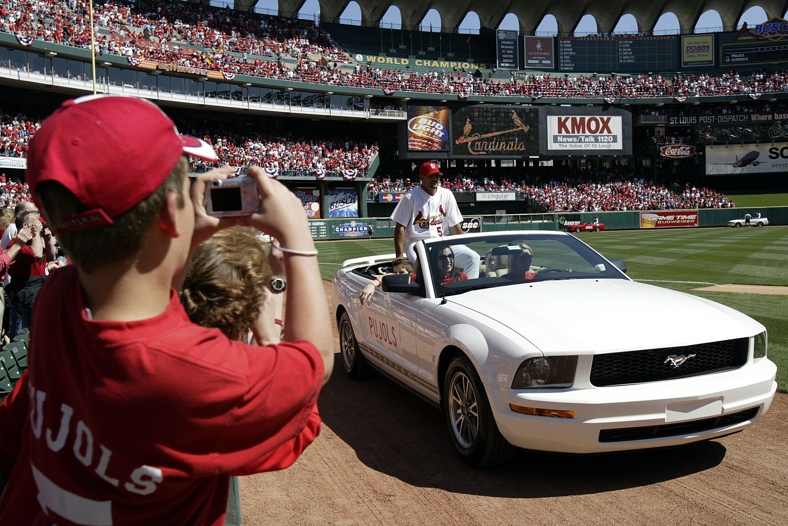 ST. LOUIS - APRIL 8:  Albert Pujols #5 of the St. Louis Cardinals takes a spin around the warning track in a Ford Mustang convertible before being introduced as part of Opening Day festivities before the game against the Philadelphia Phillies at Busch Sta