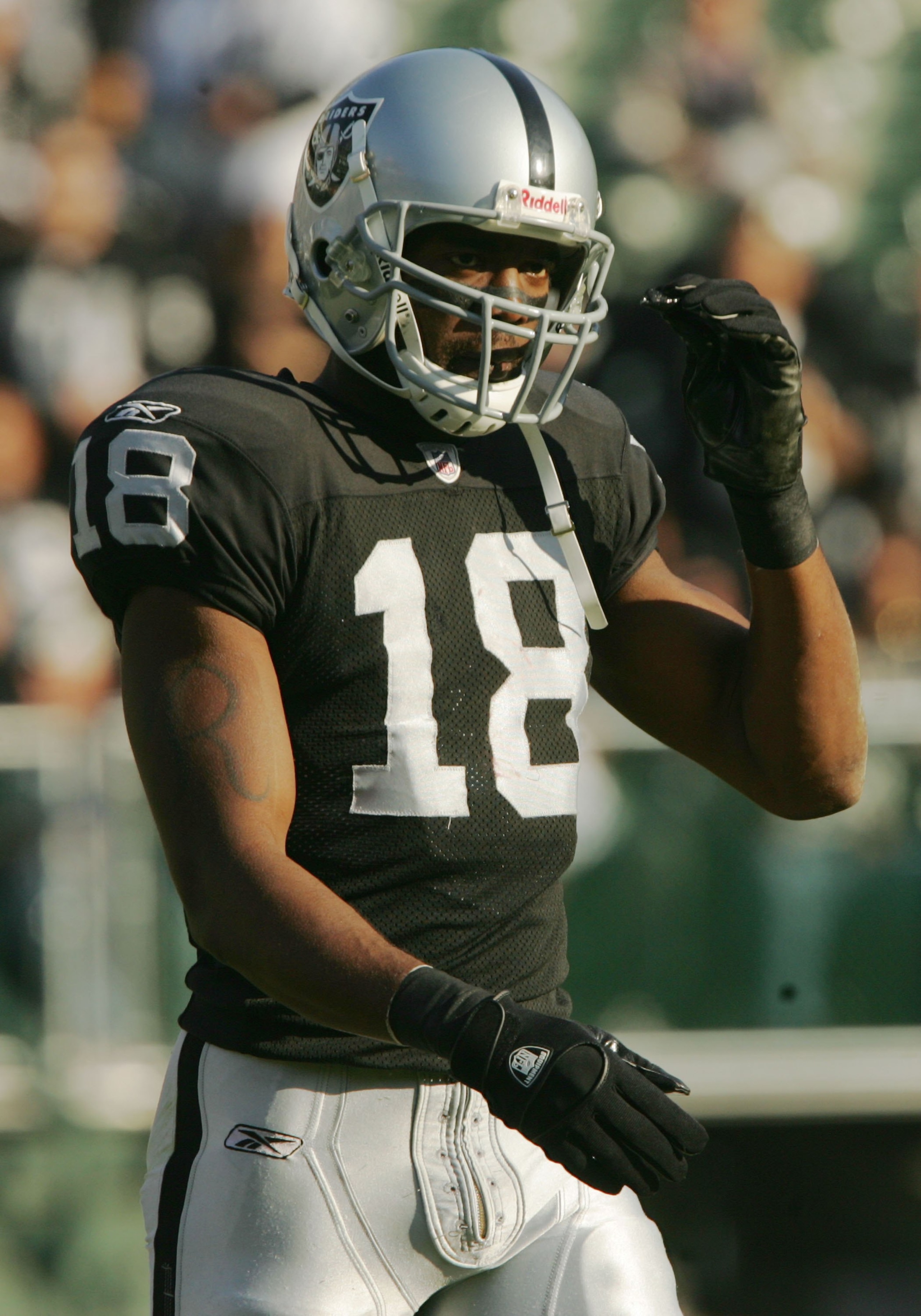 OAKLAND, CA - DECEMBER 3:  Randy Moss #18 of the Oakland Raiders reacts after a play against the Houston Texans during an NFL game at McAfee Coliseum December 3, 2006 in Oakland, California.  (Photo by Stephen Dunn/Getty Images)