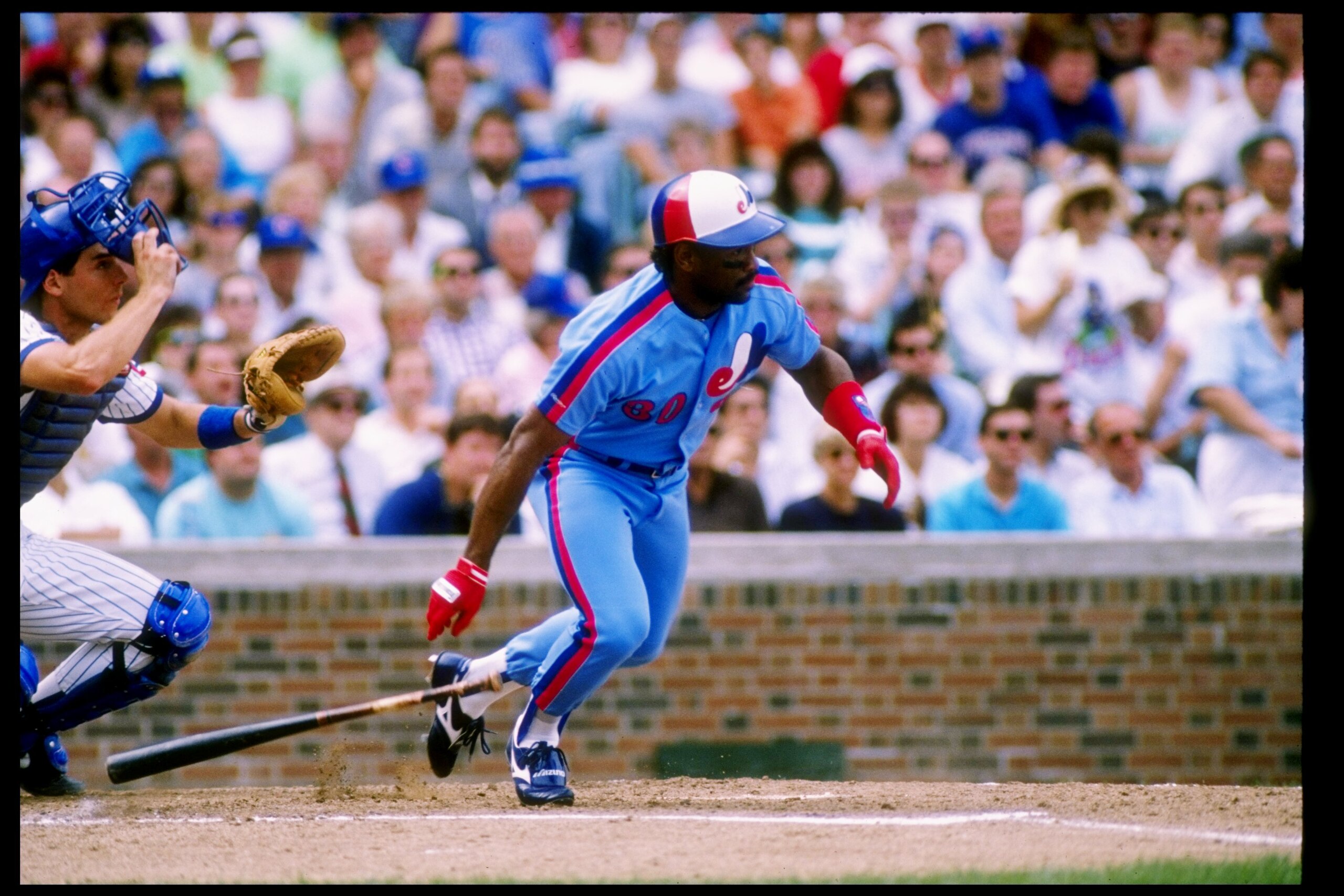 Outfielder Tim Raines of the Montreal Expos drops his bat and prepares to run.