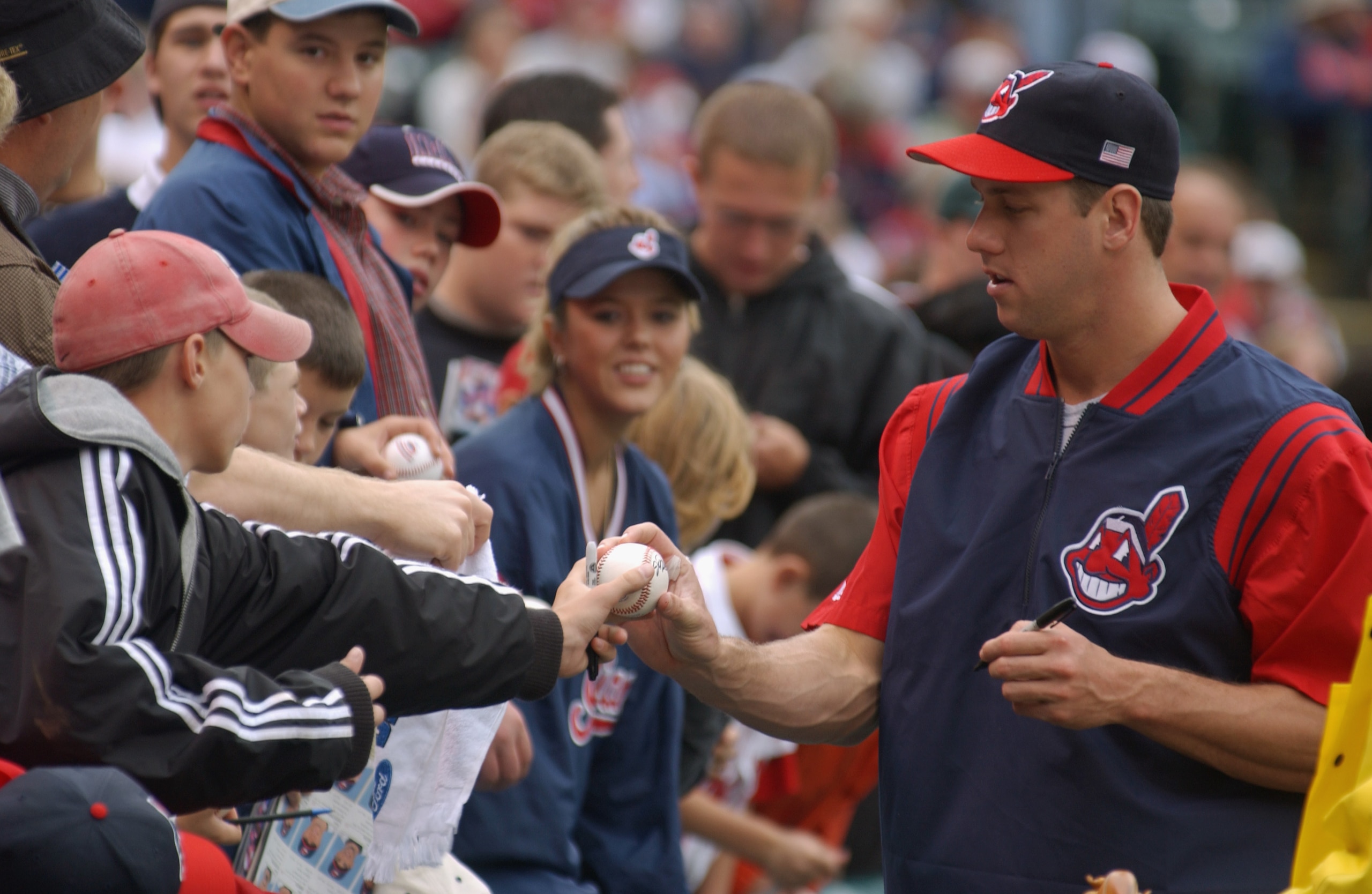 CLEVELAND - OCTOBER 14:  John Rocker #49 of the Cleveland Indians signs baseballs for young fans during Game four of the American League Division Series against the Seattle Mariners on October 14, 2001 at Jacobs Field in Cleveland, Ohio.  The Mariners won