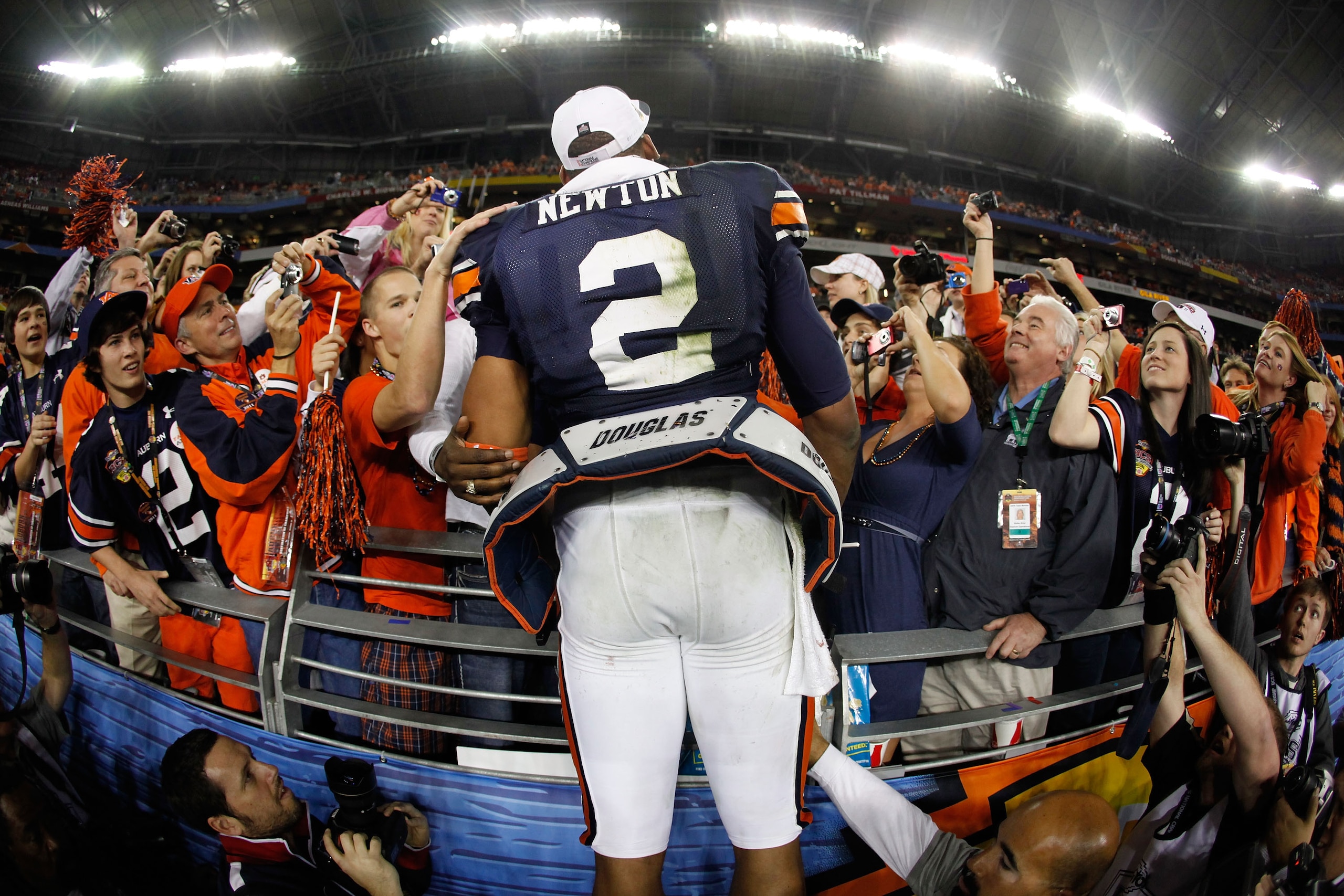 GLENDALE, AZ - JANUARY 10: Quarterback Cameron Newton #2 of the Auburn Tigers celebrates the Tigers 22-19 victory with the fans after defeating the Oregon Ducks in the Tostitos BCS National Championship Game at University of Phoenix Stadium on January 10 GLENDALE, AZ - JANUARY 10: Quarterback Cameron Newton #2 of the Auburn Tigers celebrates the Tigers 22-19 victory with the fans after defeating the Oregon Ducks in the Tostitos BCS National Championship Game at University of Phoenix Stadium on January 10