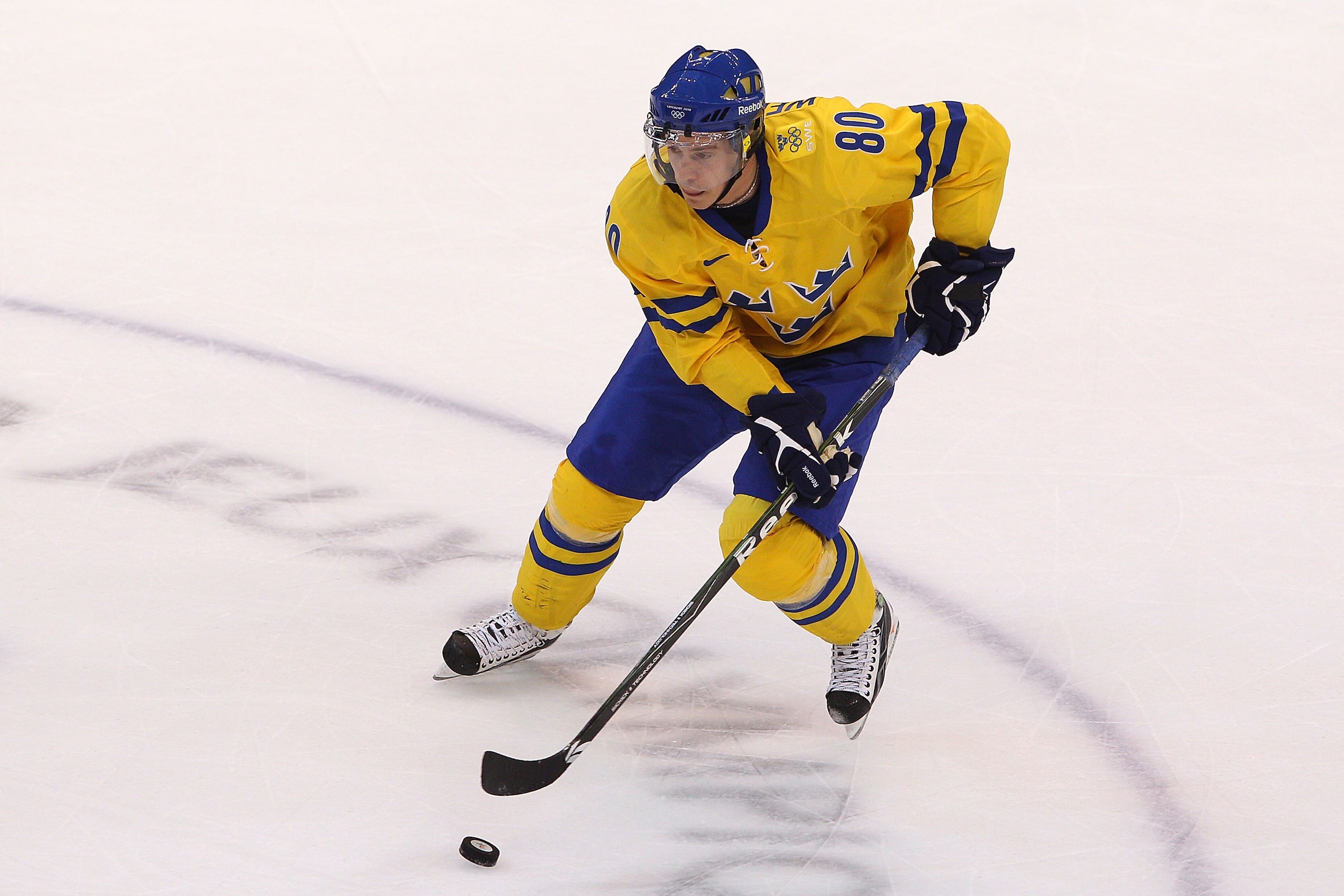 VANCOUVER, BC - FEBRUARY 24:  Mattias Weinhandl #80 of Sweden moves the puck during the ice hockey men's quarter final game between Sweden and Slovakia on day 13 of the Vancouver 2010 Winter Olympics at Canada Hockey Place on February 24, 2010 in Vancouve