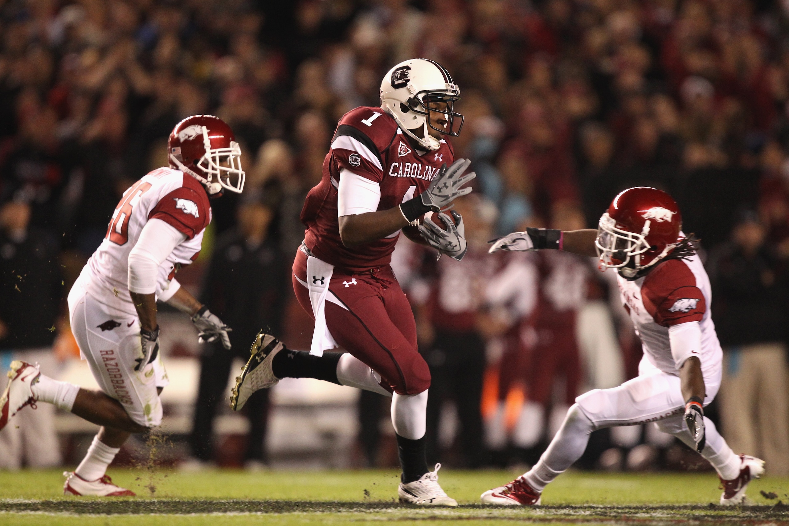 COLUMBIA, SC - NOVEMBER 06:  Teammates Rudell Crim #4 and Ramon Brown #26 of the Arkansas Razorbacks try to stop Alshon Jeffery #1 of the South Carolina Gamecocks during their game at Williams-Brice Stadium on November 6, 2010 in Columbia, South Carolina.