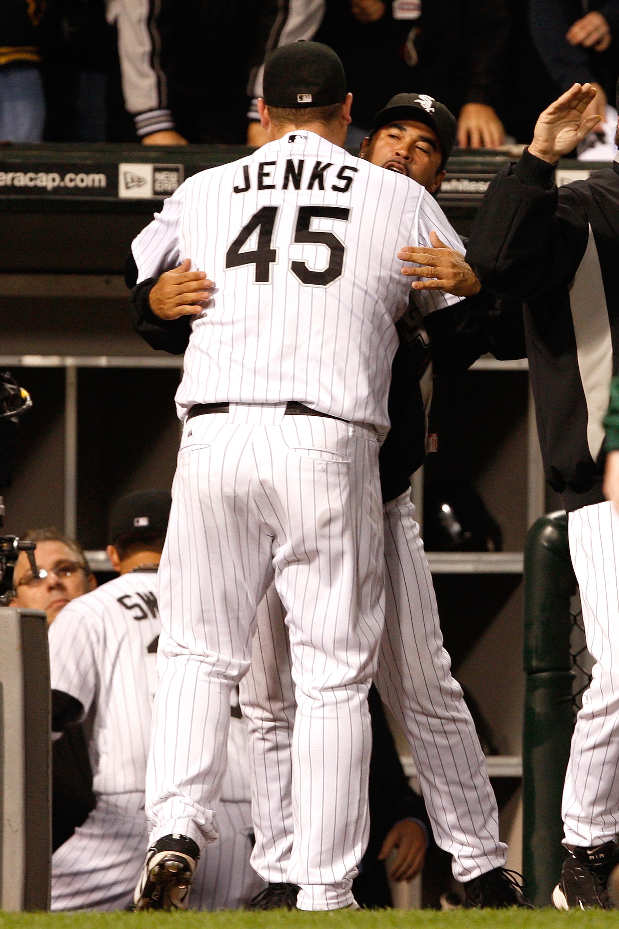 CHICAGO - OCTOBER 05:  Manager Ozzie Guillen #13 and Bobby Jenks #45 of the Chicago White Sox celebrate their 5-3 win against the Tampa Bay Rays in Game Three of the ALDS during the 2008 MLB Playoffs at U.S. Cellular Field on October 5, 2008 in Chicago, I