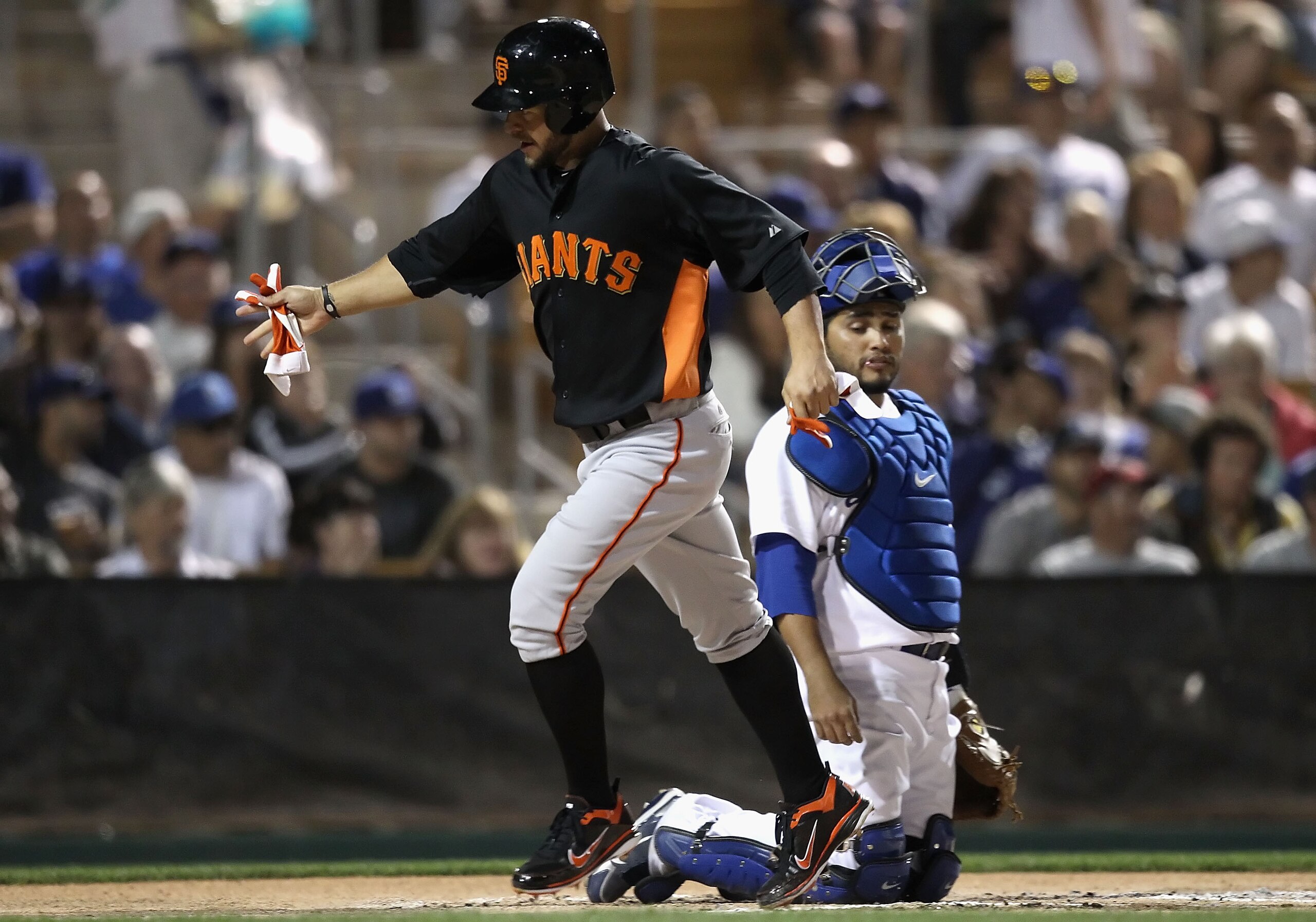 GLENDALE, AZ - MARCH 04:  Cody Ross #13 of the San Francisco Giants scores a run past catcher Dioner Navarro #30 of the Los Angeles Dodgers during the second inning of the spring training game at Camelback Ranch on March 4, 2011 in Glendale, Arizona.  (Ph