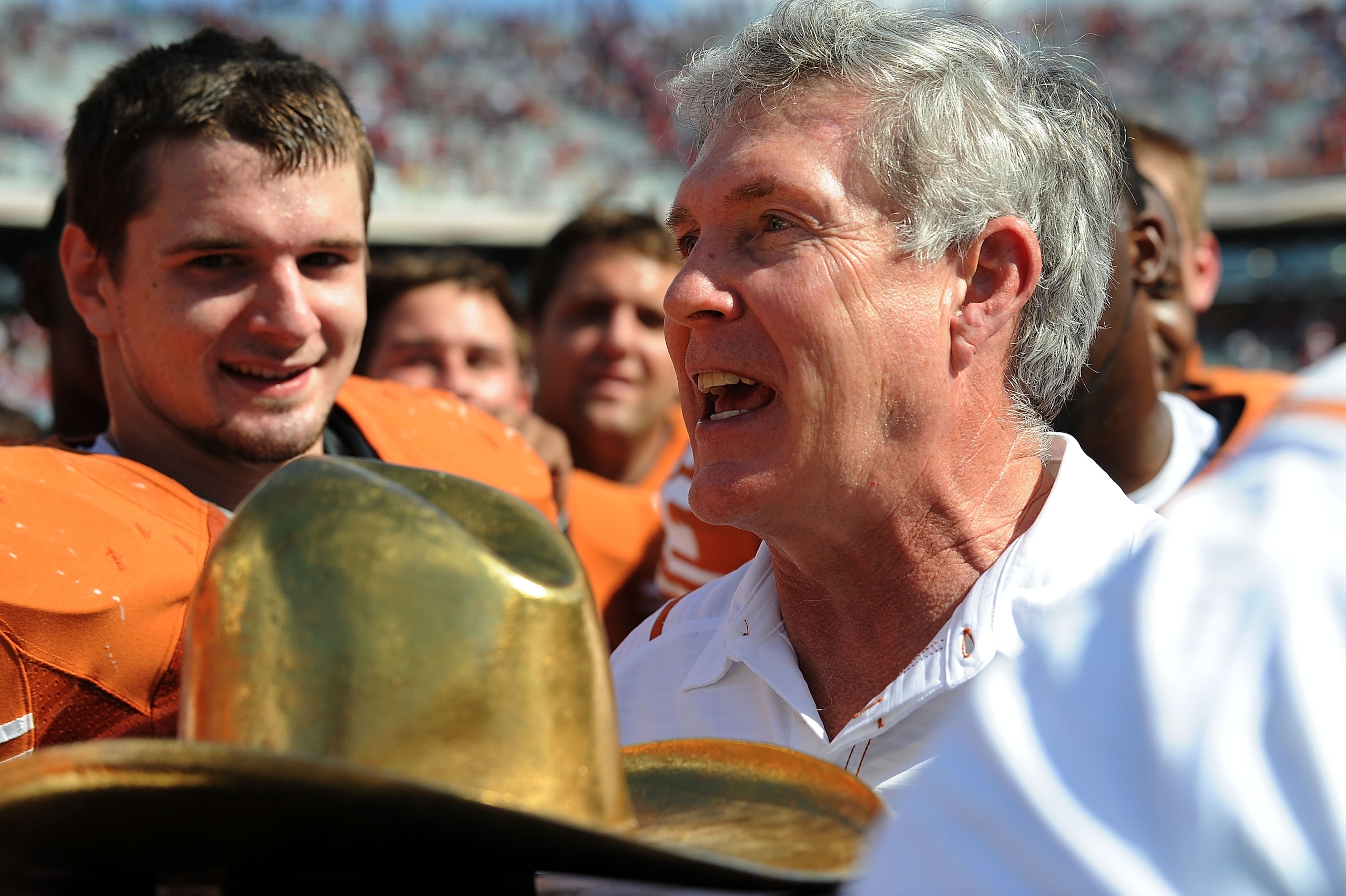 DALLAS - OCTOBER 17:  Head coach Mack Brown of the Texas Longhorns holds the Red River Rivalry trophy after a win against the Okalhoma Sooners at Cotton Bowl on October 17, 2009 in Dallas, Texas.  (Photo by Ronald Martinez/Getty Images)