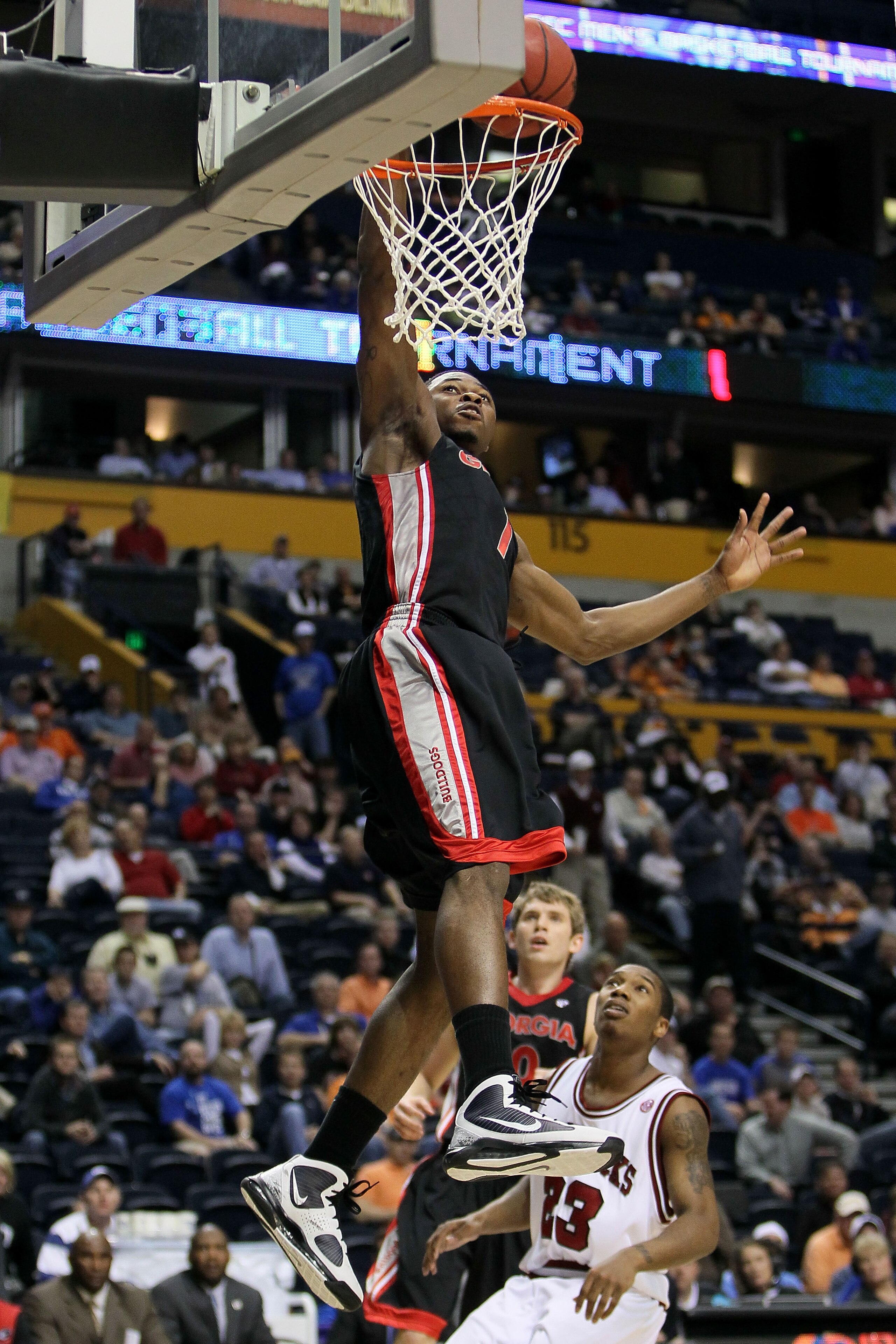 NASHVILLE, TN - MARCH 11:  Travis Leslie #1 of the Georgia Bulldogs goes up for a dunk attempt against Julysses Nobles #23 of the Arkanasas Razorbacks during the first round of the SEC Men's Basketball Tournament at the Bridgestone Arena on March 11, 2010