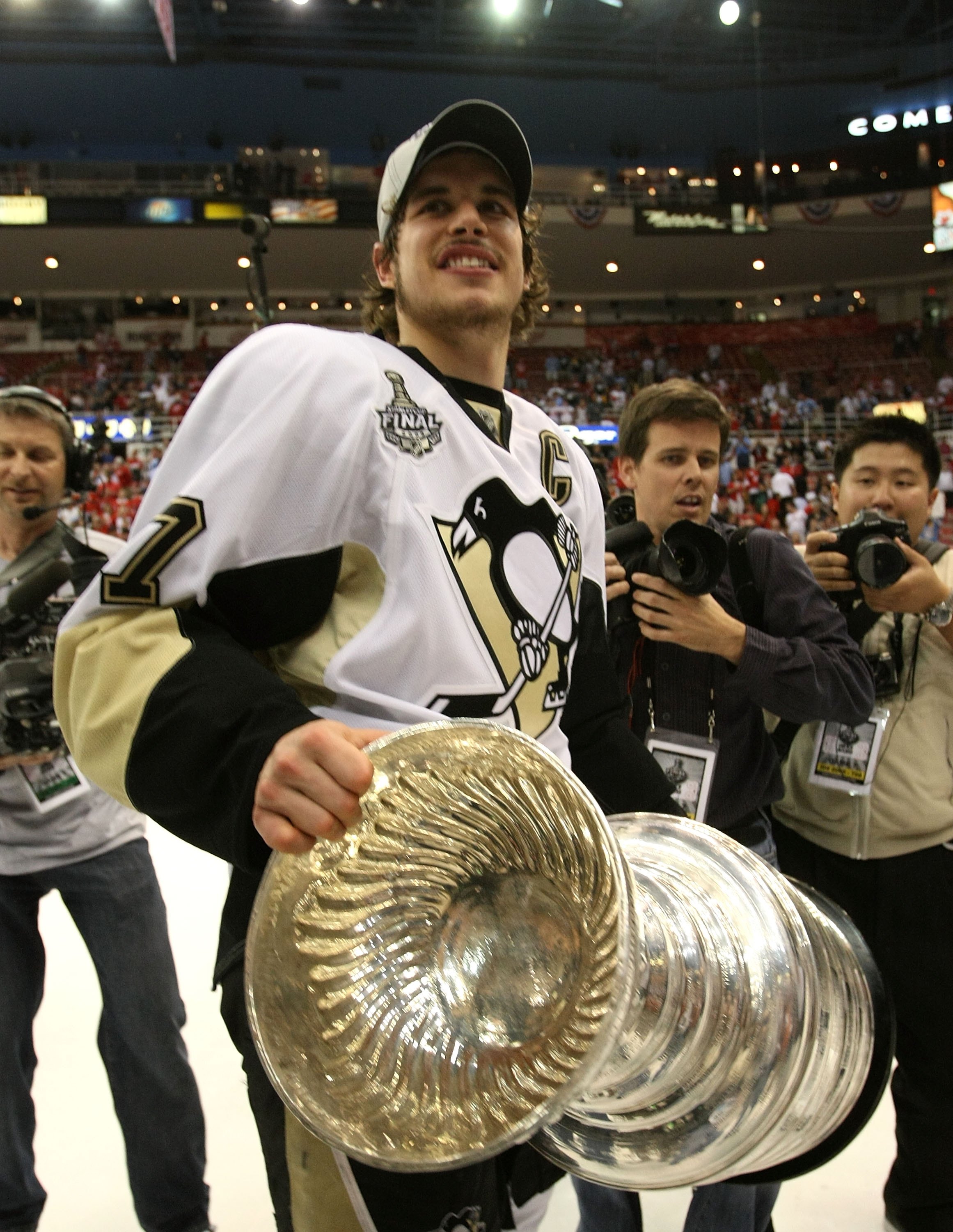 DETROIT - JUNE 12: Sidney Crosby #87 of the Pittsburgh Penguins holds the Stanley Cup following the Penguins victory over the Detroit Red Wings in Game Seven of the 2009 NHL Stanley Cup Finals at Joe Louis Arena on June 12, 2009 in Detroit, Michigan. (P