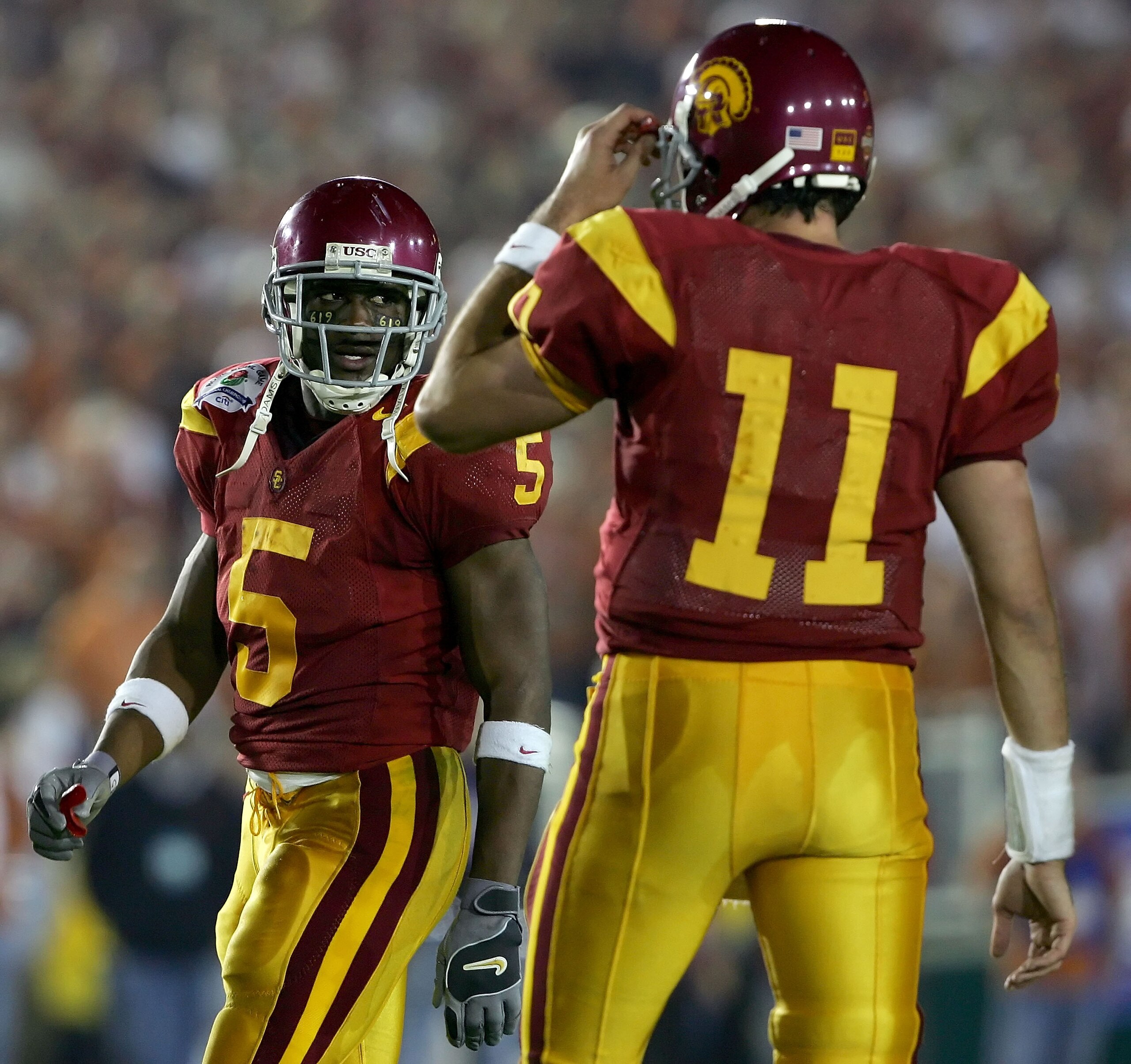 PASADENA, CA - JANUARY 04:  Reggie Bush #5 walks past quarterback Matt Leinart #11 of the USC Trojans during the first half of the BCS National Championship Rose Bowl Game against the Texas Longhorns at the Rose Bowl on January 4, 2006 in Pasadena, Califo