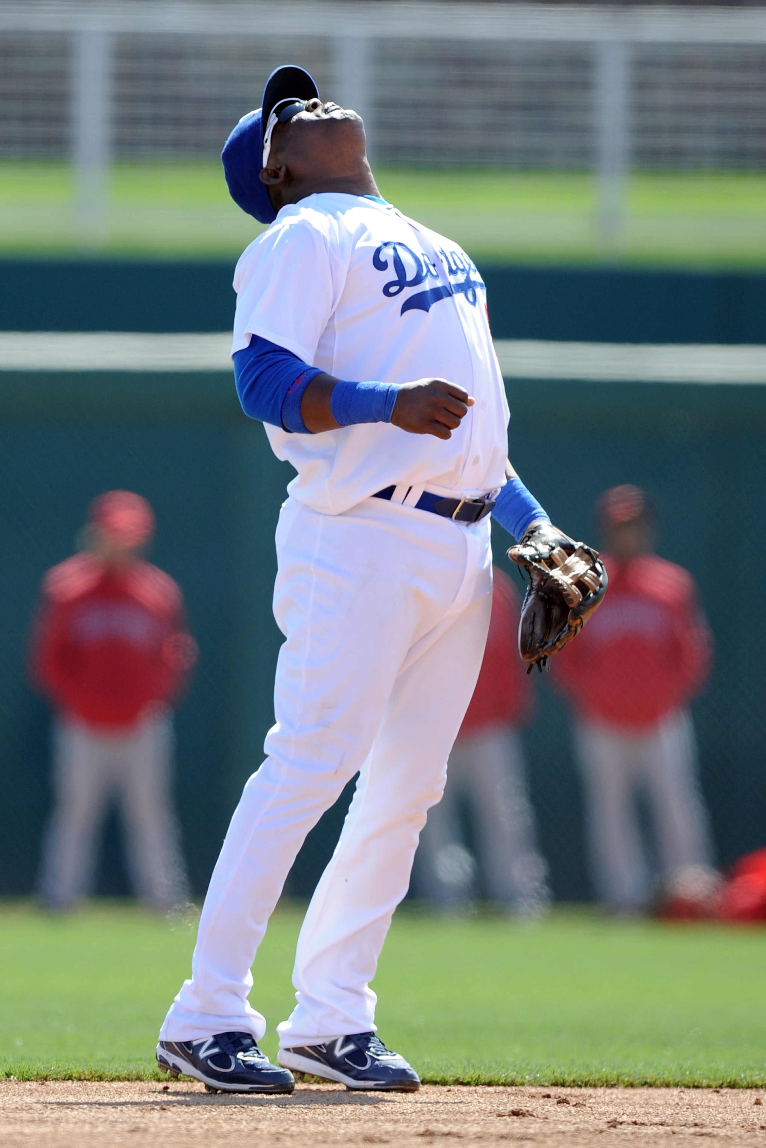 PHOENIX, AZ - FEBRUARY 27:  Juan Uribe #5 of the  Los Angeles Dodgers reacts to his throwing error during spring training at Camelback Ranch on February 27, 2011 in Phoenix, Arizona.  (Photo by Harry How/Getty Images)