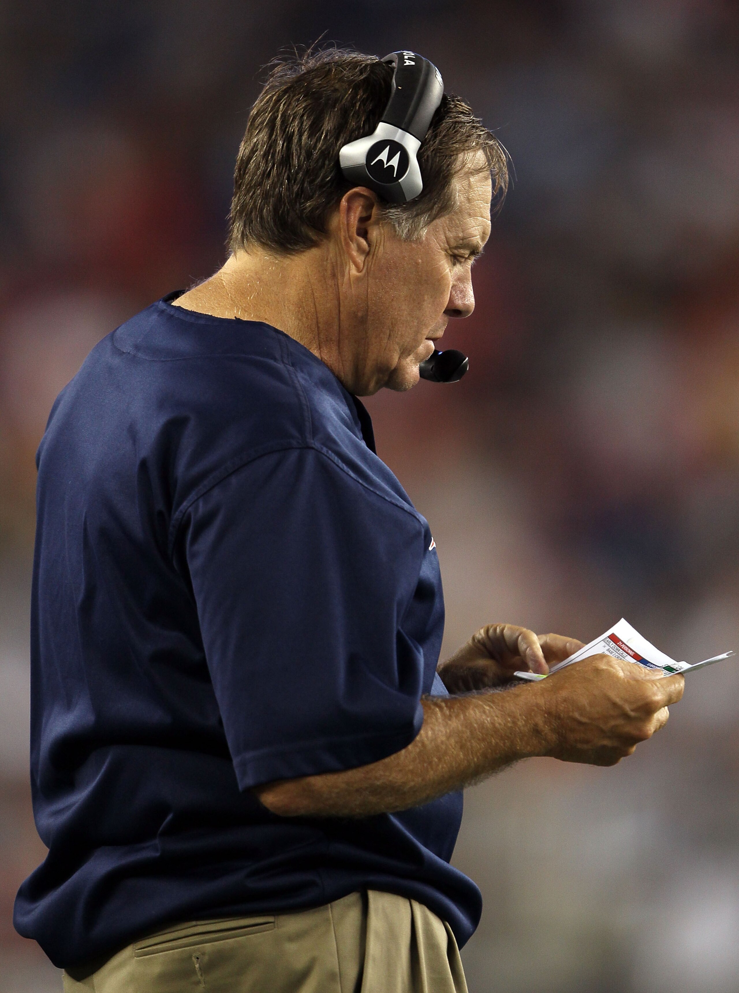 FOXBORO, MA - AUGUST 26:  Head coach Bill Belichick of the New England Patriots looks at his plays from the sideline in the first half against the St. Louis Rams on August 26, 2010 at Gillette Stadium in Foxboro, Massachusetts.  (Photo by Elsa/Getty Image