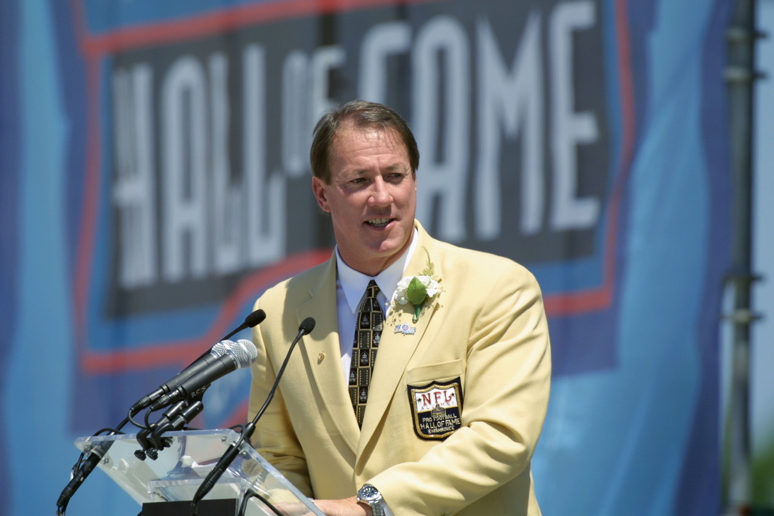 CANTON, OHIO - AUGUST 3:  Jim Kelly speaks at the  podium during his induction into the National Football League Hall of Fame on August 3, 2002 at Fawcett Stadium in Canton, Ohio.  Kelly played quarterback for the Buffalo Bills from 1986 to 1996 and led t