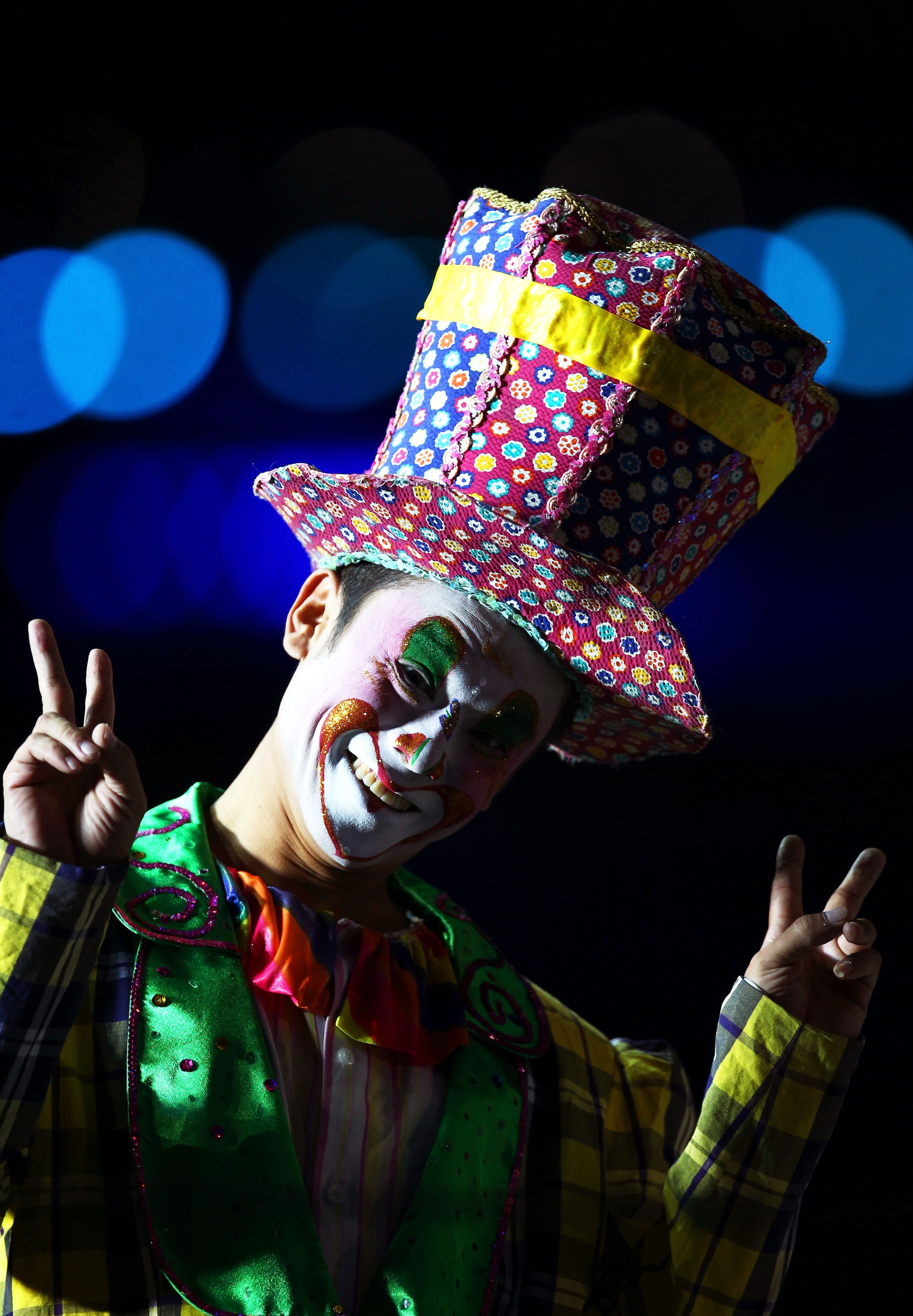 GUANGZHOU, CHINA - NOVEMBER 12:  A performer dressed as a clown smiles during the Opening Ceremony for the 16th Asian Games Guangzhou 2010 at Haixinsha Square on November 12, 2010 in Guangzhou, China.  (Photo by Hannah Johnston/Getty Images)