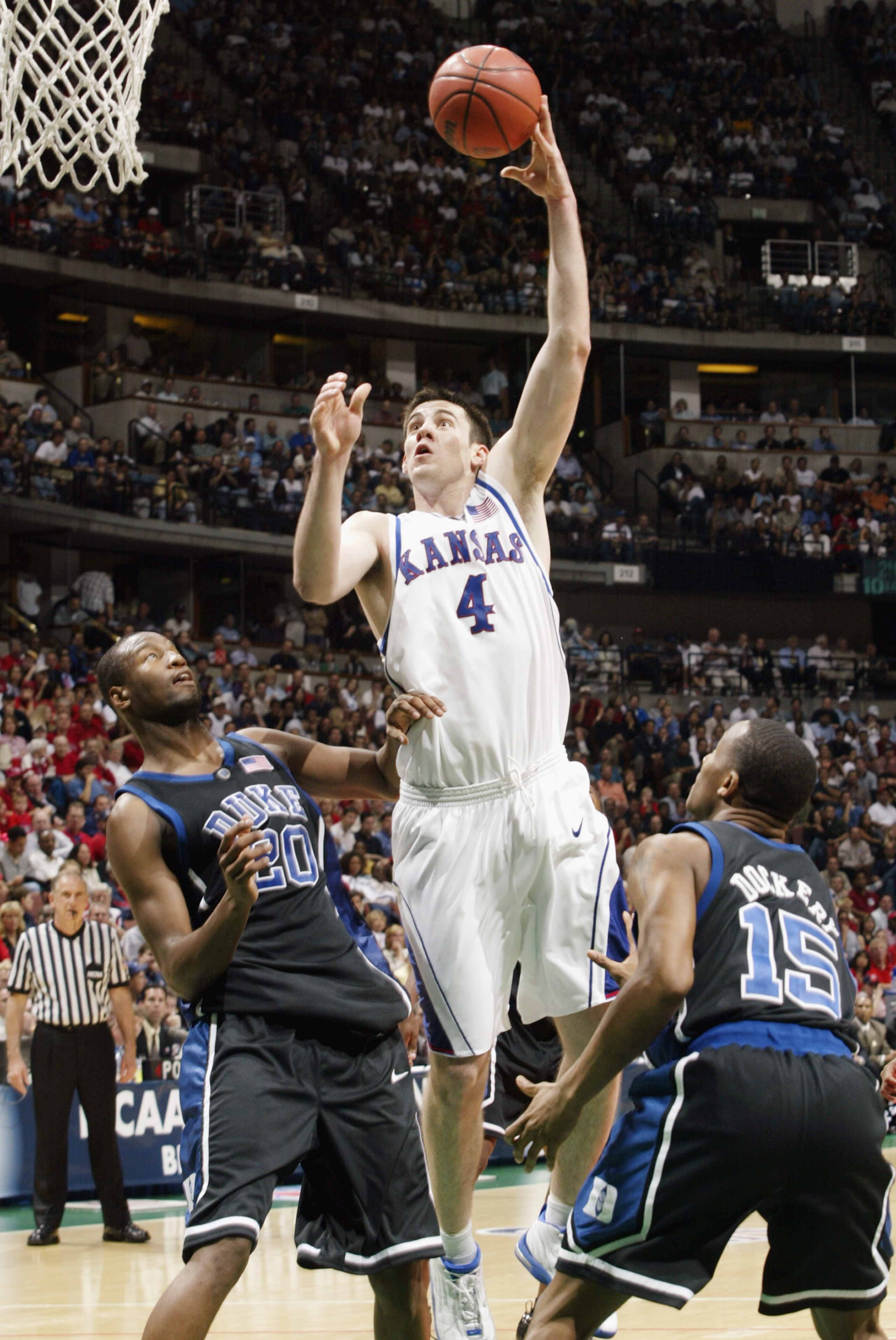 ANAHEIM, CA - MARCH 27: Nick Collison #4 of Kansas shoots over the defense of Casey Sanders #20 and Sean Dockery #15 of Duke during the NCAA Tournament at the Arrowhead Pond on March 27, 2003 in Anaheim, California. Kansas defeated Duke 69-65. (Photo b ANAHEIM, CA - MARCH 27: Nick Collison #4 of Kansas shoots over the defense of Casey Sanders #20 and Sean Dockery #15 of Duke during the NCAA Tournament at the Arrowhead Pond on March 27, 2003 in Anaheim, California. Kansas defeated Duke 69-65. (Photo b