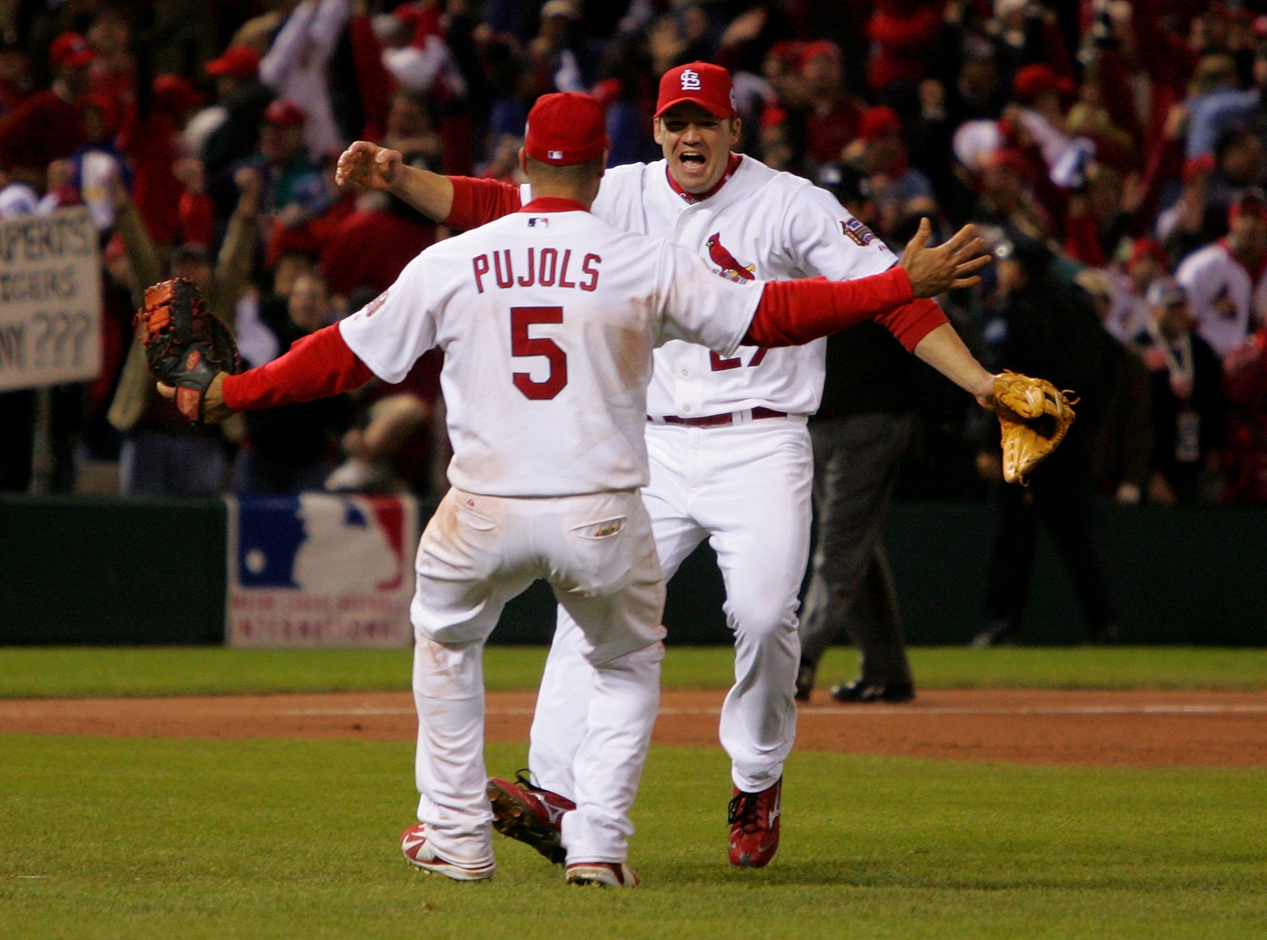 ST LOUIS, MO - OCTOBER 27:  Scott Rolen #27 and Albert Pujols #5 of the St. Louis Cardinals celebrate after defeating the Detroit Tigers in Game Five of the 2006 World Series on October 27, 2006 at Busch Stadium in St. Louis, Missouri.  The Cardinals defe
