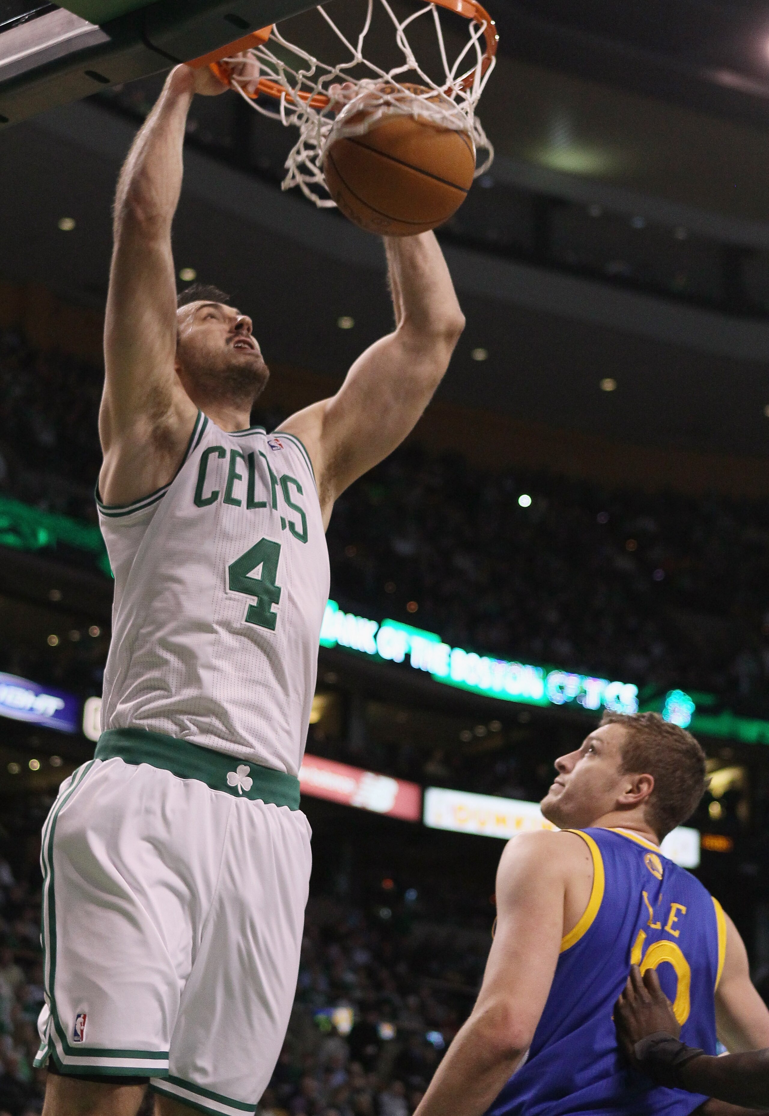 BOSTON, MA - MARCH 04:  Nenad Krstic #4 of the Boston Celtics dunks over David Lee #10 of the Golden State Warriors on March 4, 2011 at the TD Garden in Boston, Massachusetts.  NOTE TO USER: User expressly acknowledges and agrees that, by downloading and/