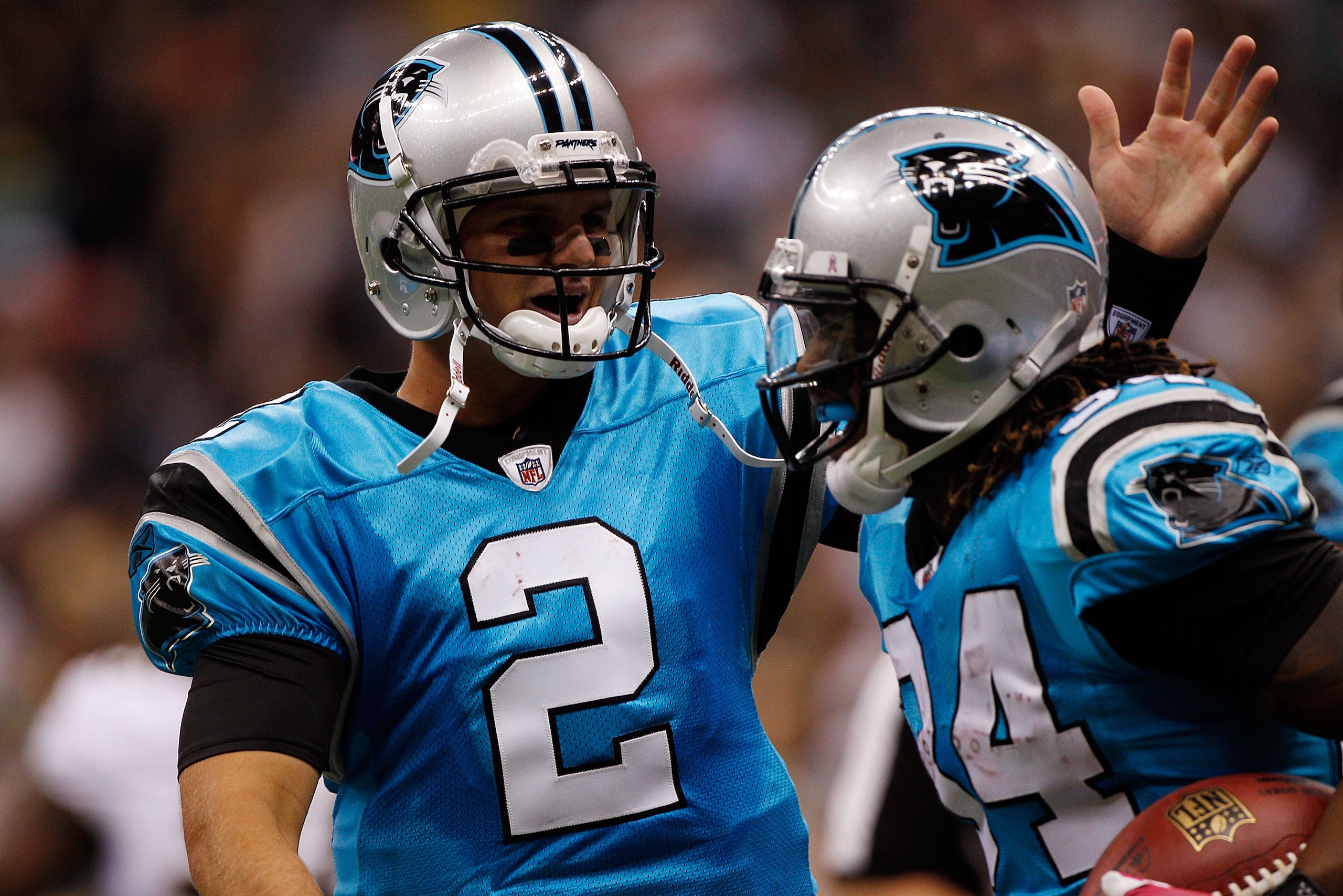 NEW ORLEANS - OCTOBER 03:  Jimmy Clausen #2 celebrates with DeAngelo Williams #34 of the Carolina Panthers after scoring a touchdown against the New Orleans Saints at the Louisiana Superdome on October 3, 2010 in New Orleans, Louisiana.   The Saints defea
