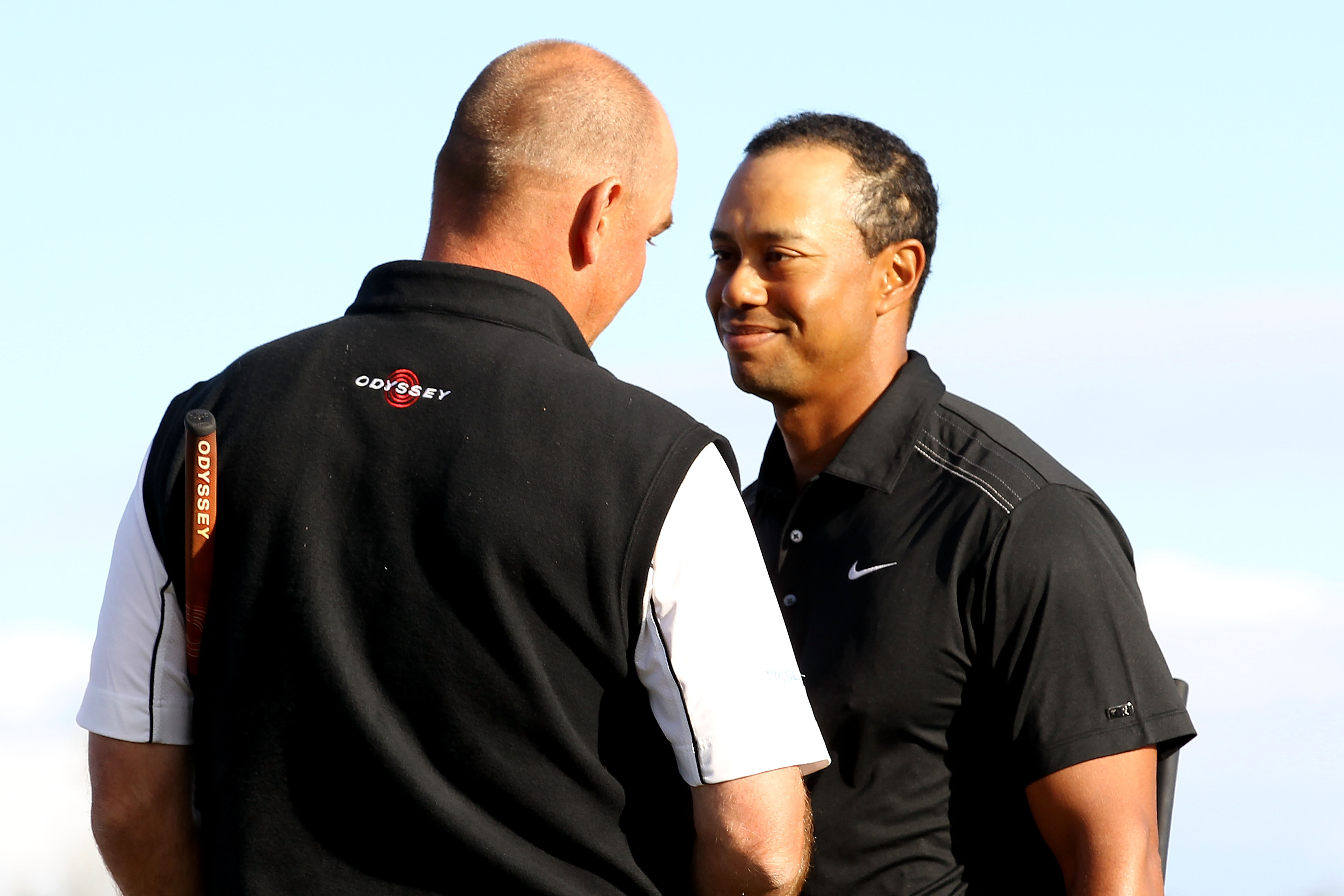 MARANA, AZ - FEBRUARY 23:  Tiger Woods (R) congratulates Thomas Bjorn of Denmark (L) on his win on the 19th hole during the first round of the Accenture Match Play Championship at the Ritz-Carlton Golf Club on February 23, 2011 in Marana, Arizona.  (Photo