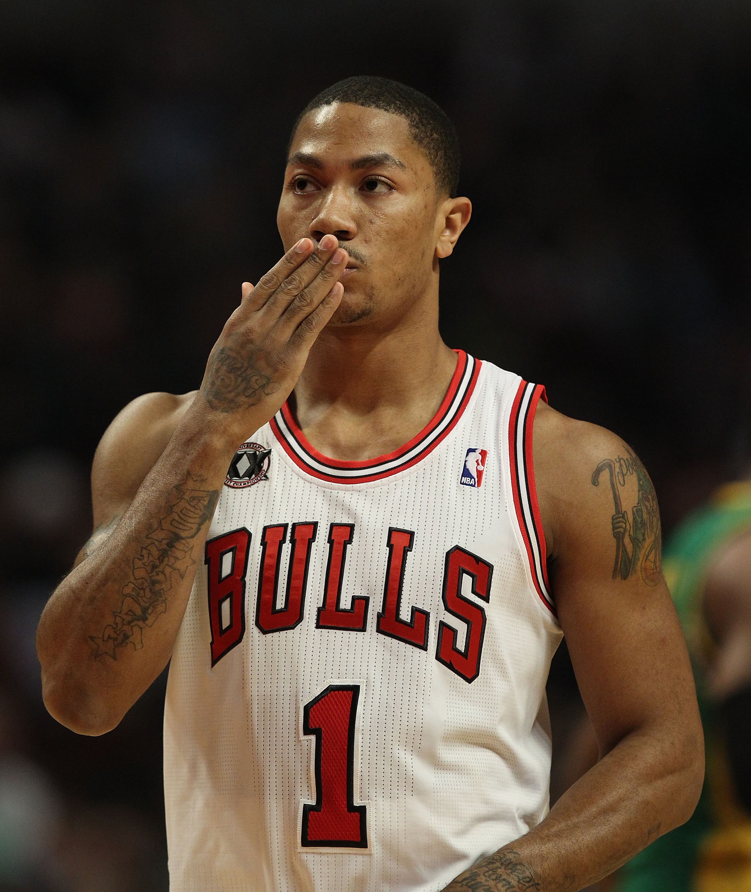 CHICAGO, IL - MARCH 07: Derrick Rose #1 of the Chicago Bulls blows a kiss to members of his family in the stands before the tip-off of a game against the New Orleans Hornets at the United Center on March 7, 2011 in Chicago, Illinois. NOTE TO USER: User ex