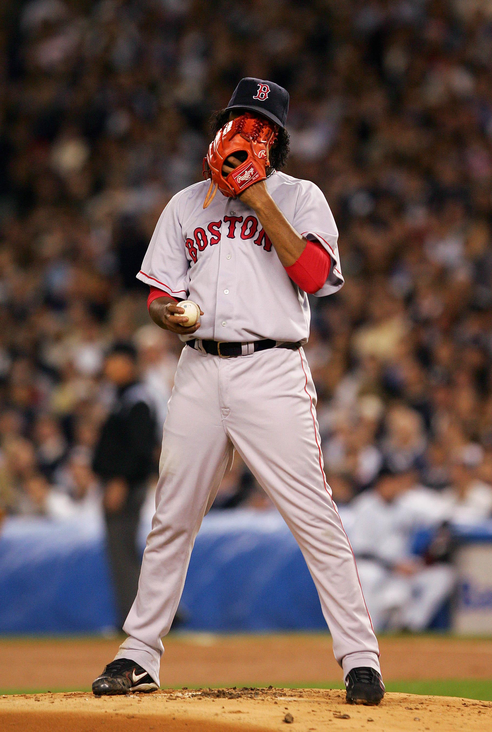 NEW YORK - OCTOBER 13:  Pedro Martinez #45 of the Boston Red Sox covers his face with his glove in between pitches against the New York Yankees during game two of the American League Championship Series on October 13, 2004 at Yankee Stadium in the Bronx b