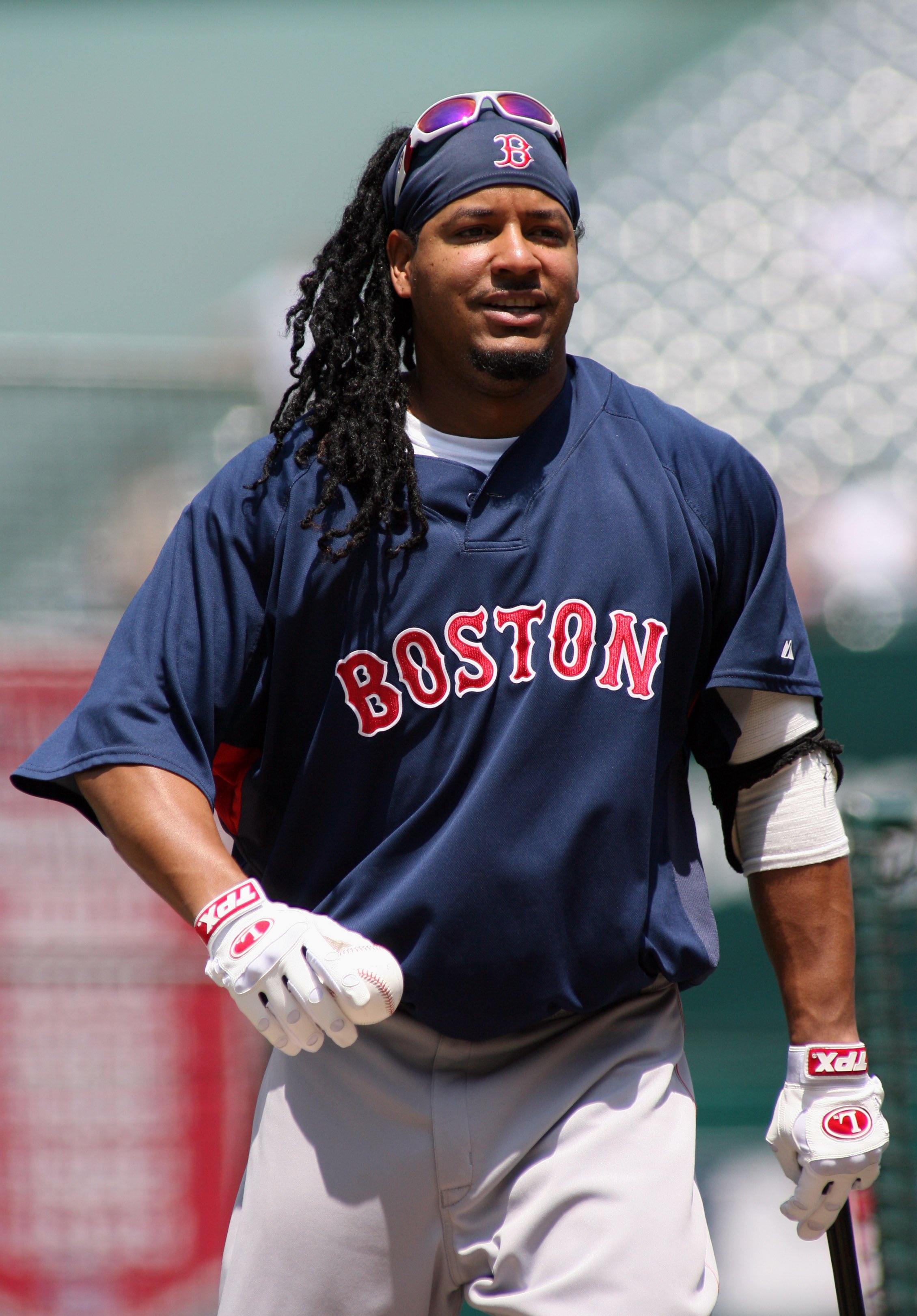 ANAHEIM, CA - JULY 20:  Manny Ramirez #24 of the Boston Red Sox walks with a bat and ball during practice before the game against the Los Angeles Angels of Anaheim at Angels Stadium on July 20, 2008 in Anaheim, California.  (Photo by Christian Petersen/Ge