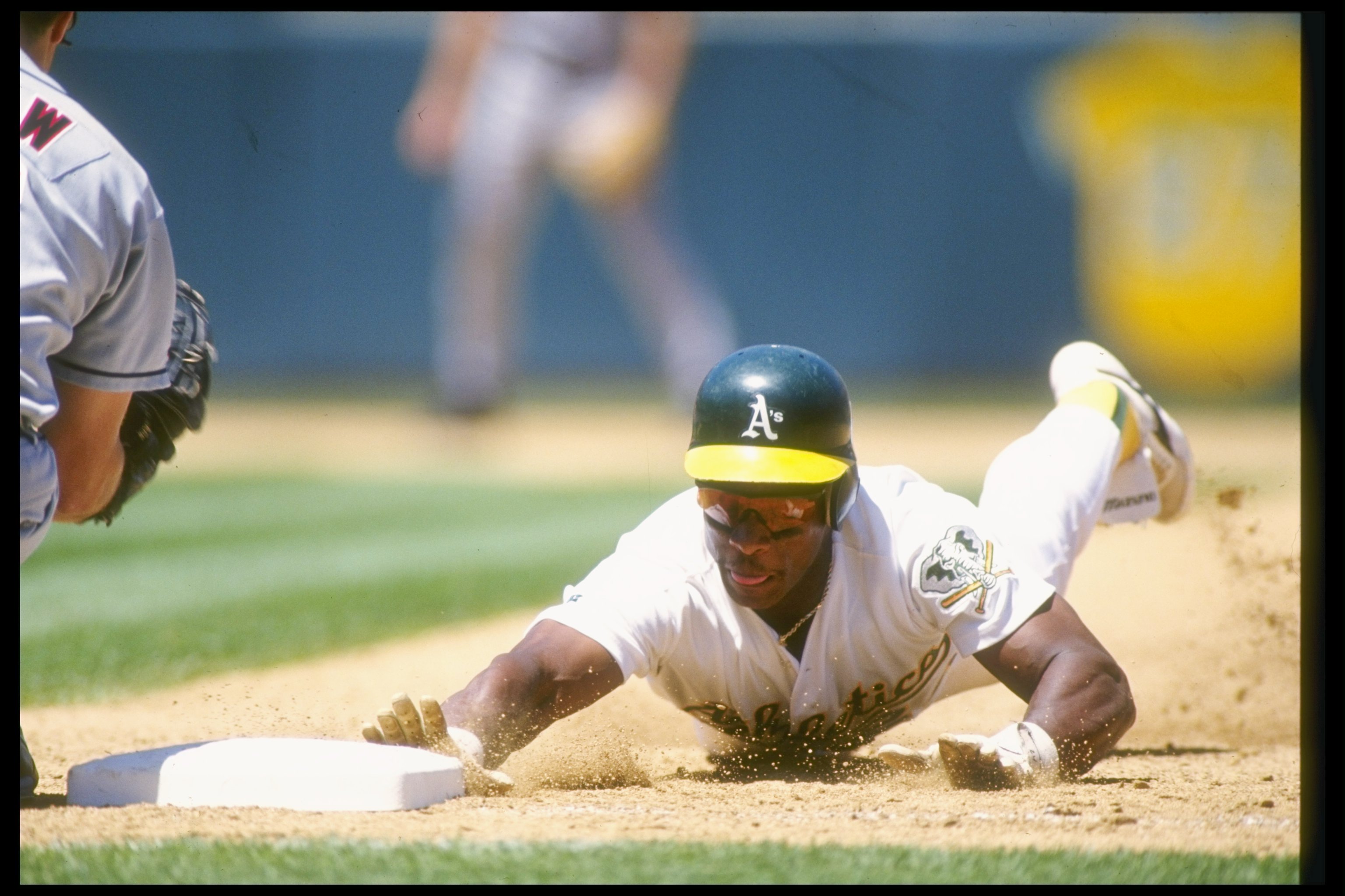 1 Jul 1993:  Outfielder Rickey Henderson of the Oakland Athletics slides into base during a game against the California Angels at the Oakland Coliseum in Oakland, California. Mandatory Credit: Otto Greule  /Allsport