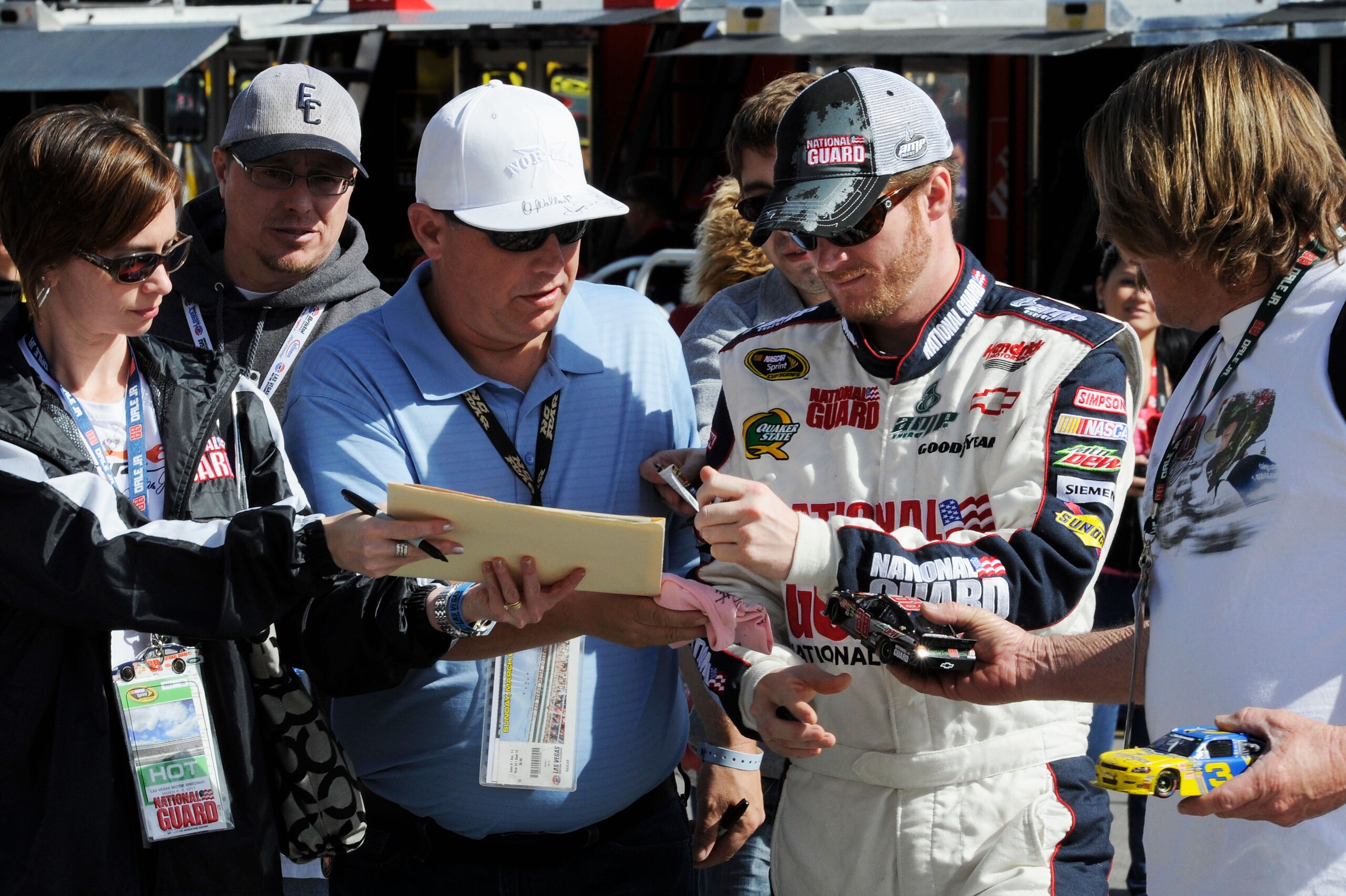 LAS VEGAS, NV - MARCH 05:  Dale Earnhardt Jr., driver of the #88 National Guard/Amp Energy Chevrolet, signs his autograph in the garage area during practice for the NASCAR Sprint Cup Series Kobalt Tools 400 at Las Vegas Motor Speedway on March 5, 2011 in