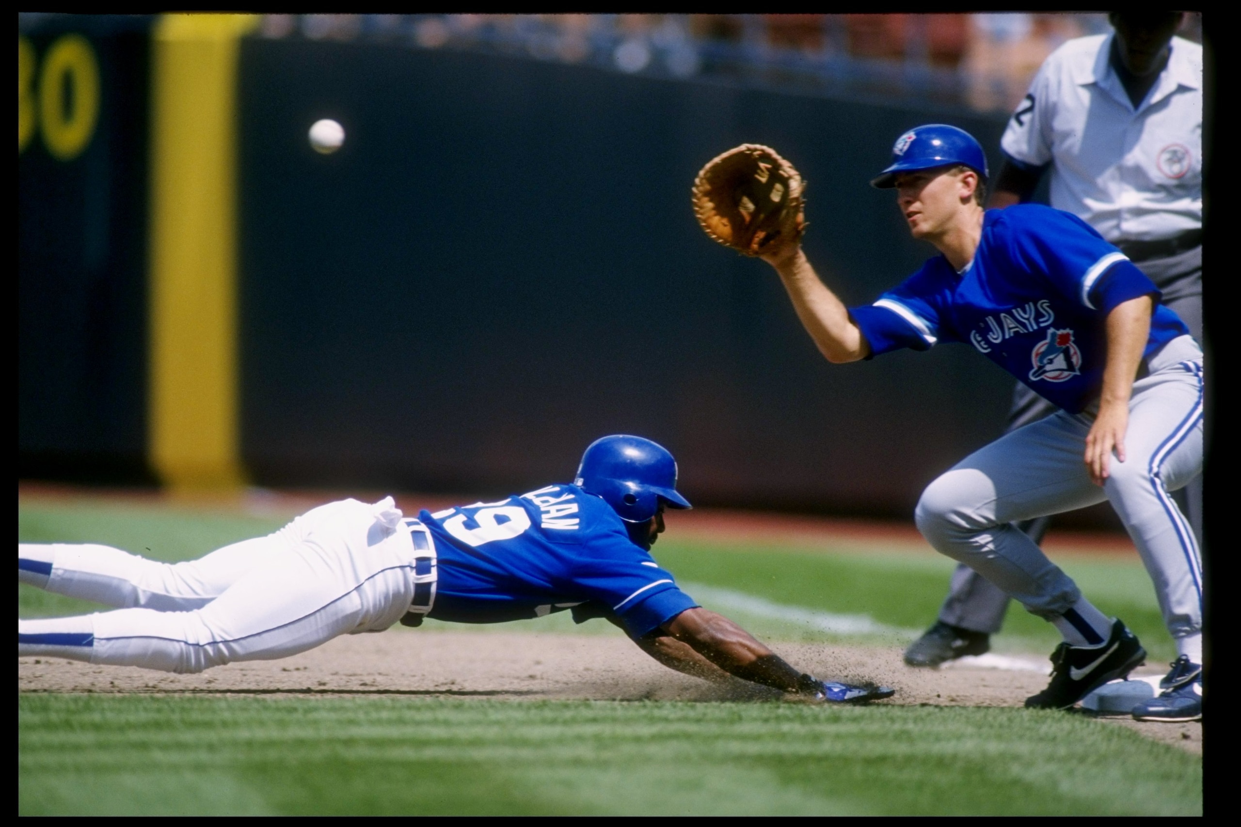 11 Jun 1995:  Infielder John Olerud of the Toronto Blue Jays tries to tag out Vince Coleman of the Kansas City Royals at Royals Stadium in Kansas City, Missouri.  The Royals won the game 2-1. Mandatory Credit: Stephen Dunn  /Allsport