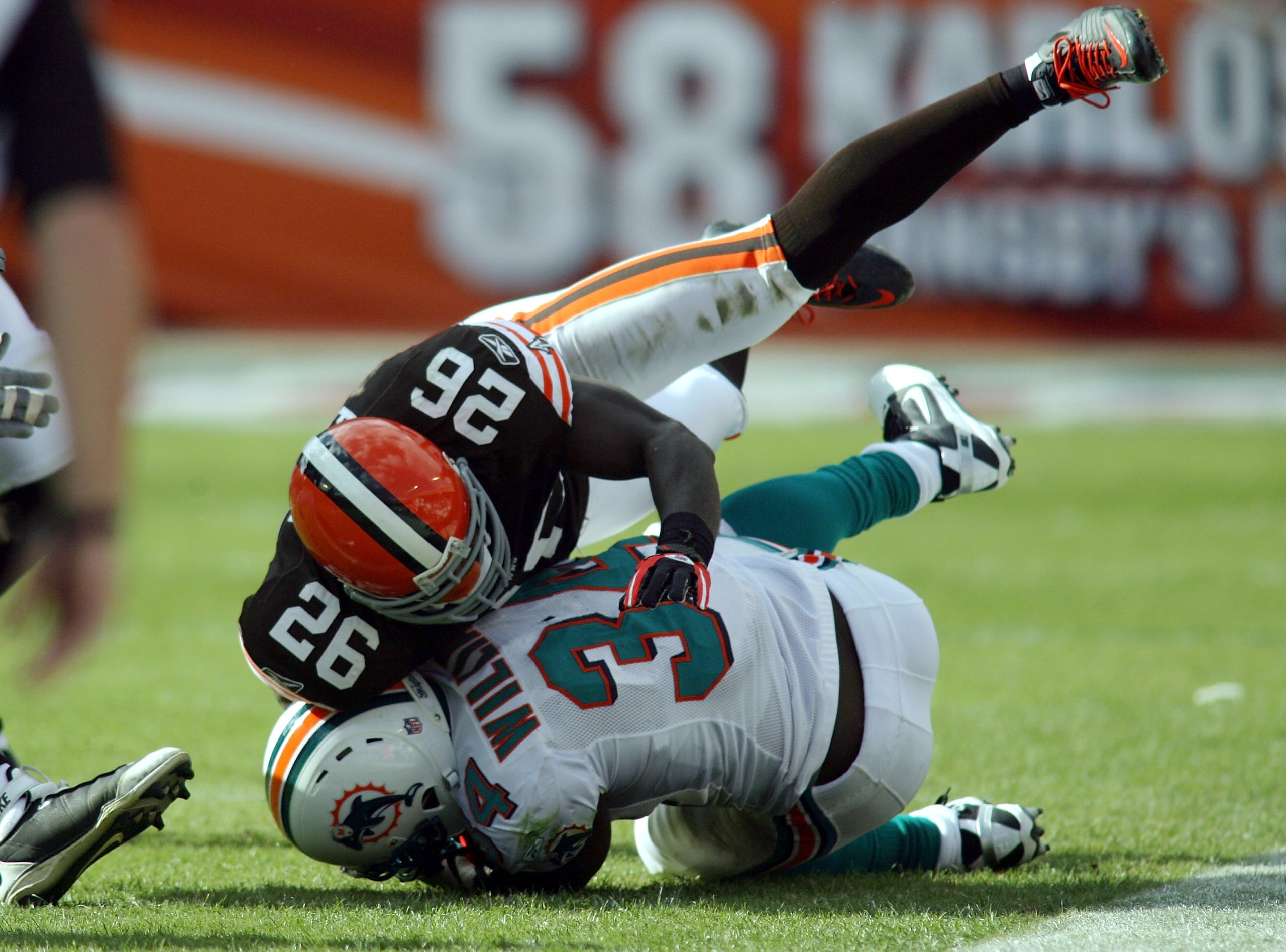 MIAMI - DECEMBER 05:  Running back Ricky Williams #34 of the Miami Dolphins is brought down by Abram Elam #26 of the Cleveland Browns at Sun Life Stadium on December 5, 2010 in Miami, Florida. Cleveland defeated miami 13-10. (Photo by Marc Serota/Getty Im