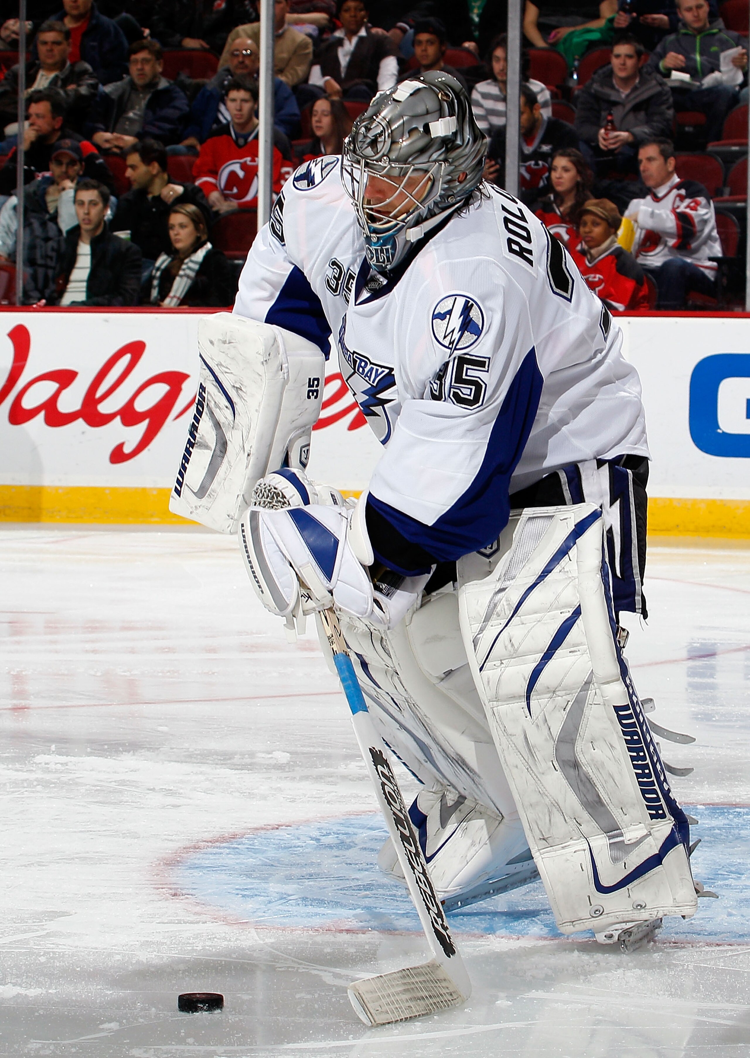 NEWARK, NJ - MARCH 02:  Goalie Dwayne Roloson #35 of the Tampa Bay Lightning clears the puck during an NHL hockey game against the New Jersey Devils at the Prudential Center on March 2, 2011 in Newark, New Jersey.  (Photo by Paul Bereswill/Getty Images)