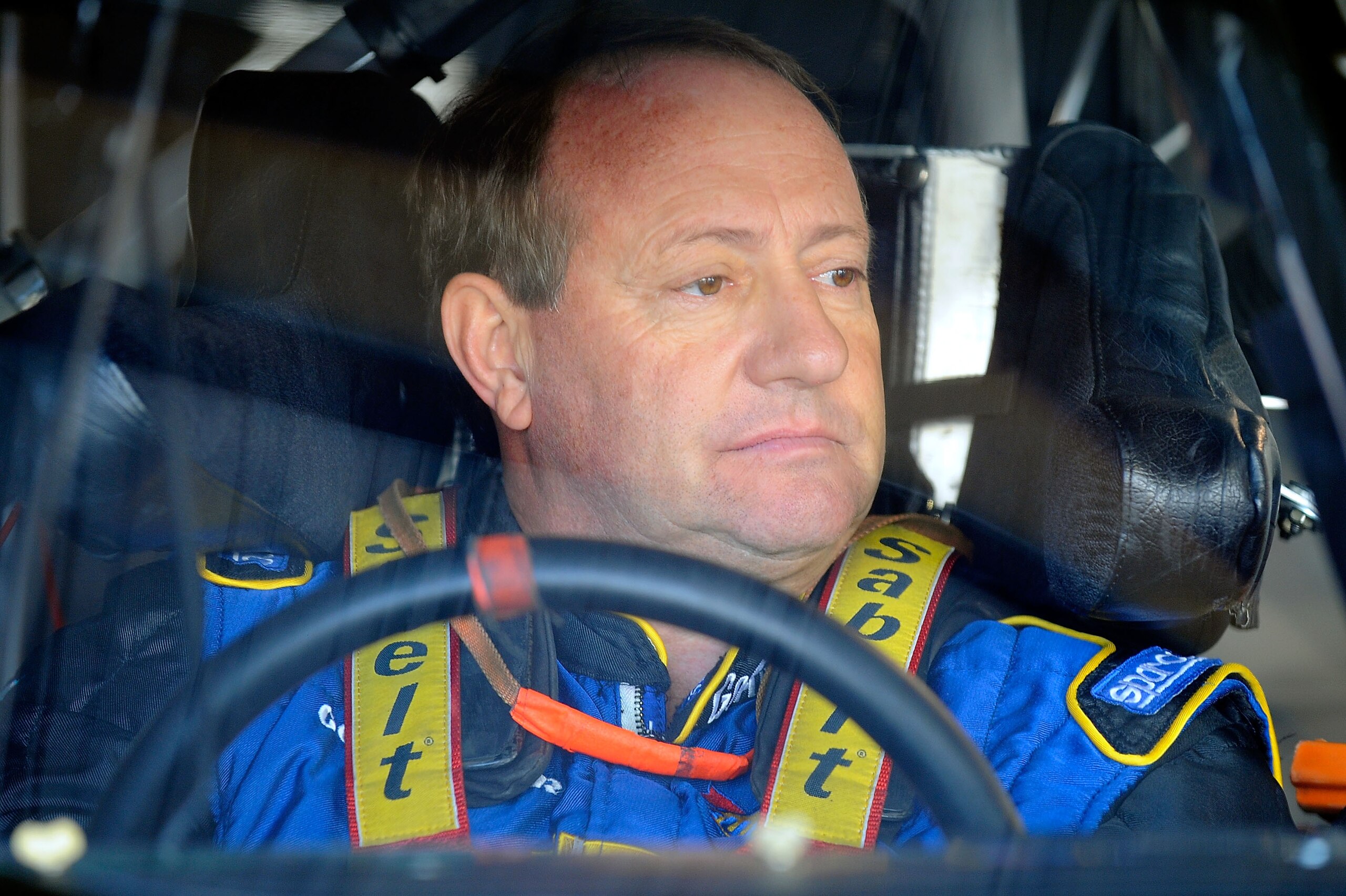 MARTINSVILLE, VA - OCTOBER 22:  Ken Schrader, driver of the #26 Air Guard Chevrolet, sits in his car during practice for the NASCAR Sprint Cup Series TUMS Fast Relief 500 at Martinsville Speedway on October 22, 2010 in Martinsville, Virginia.  (Photo by J