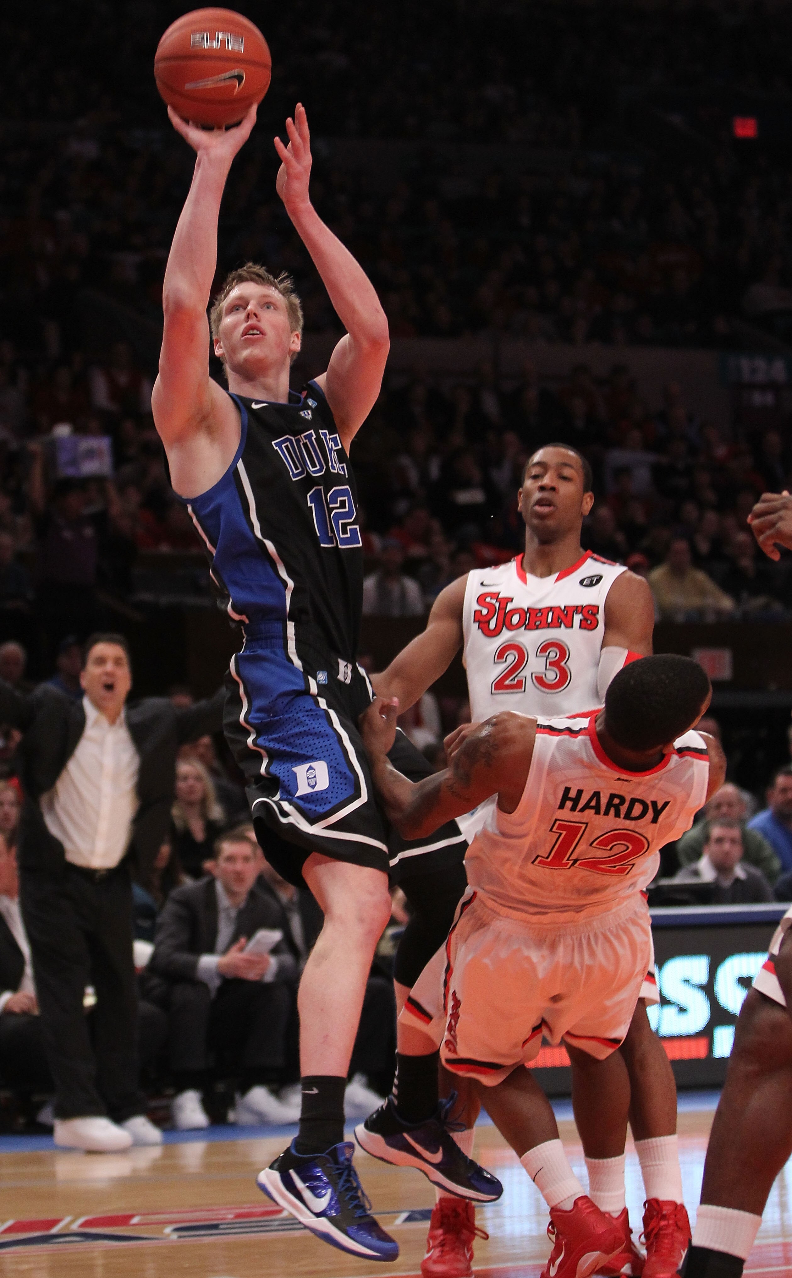 NEW YORK, NY - JANUARY 30:  Kyle Singler #12 of the Duke Blue Devils shoots the ball over Dwight Hardy #12 of the St. John's Red Storm at Madison Square Garden on January 30, 2011 in New York City.  (Photo by Nick Laham/Getty Images)