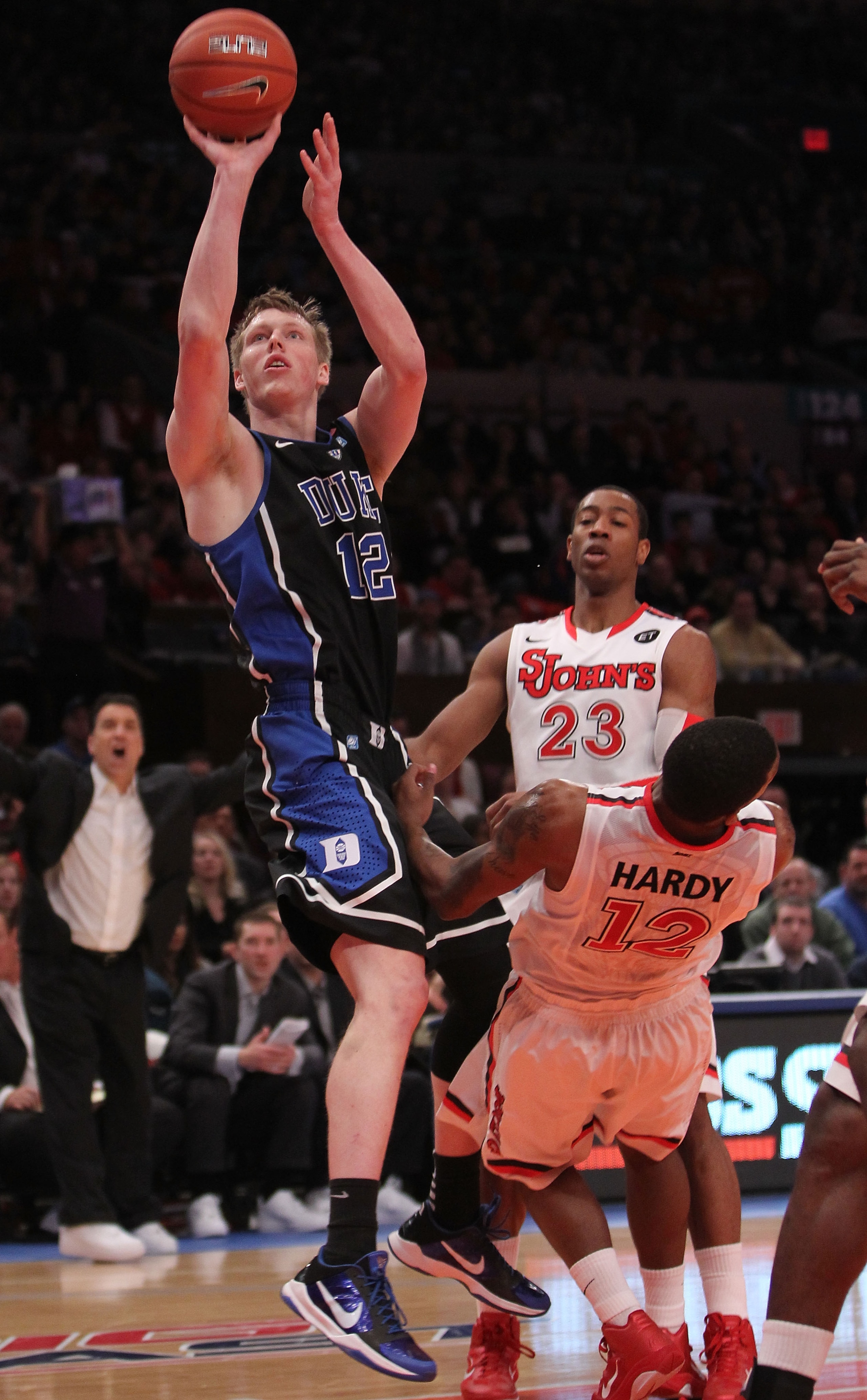 NEW YORK, NY - JANUARY 30:  Kyle Singler #12 of the Duke Blue Devils shoots the ball over Dwight Hardy #12 of the St. John's Red Storm at Madison Square Garden on January 30, 2011 in New York City.  (Photo by Nick Laham/Getty Images)