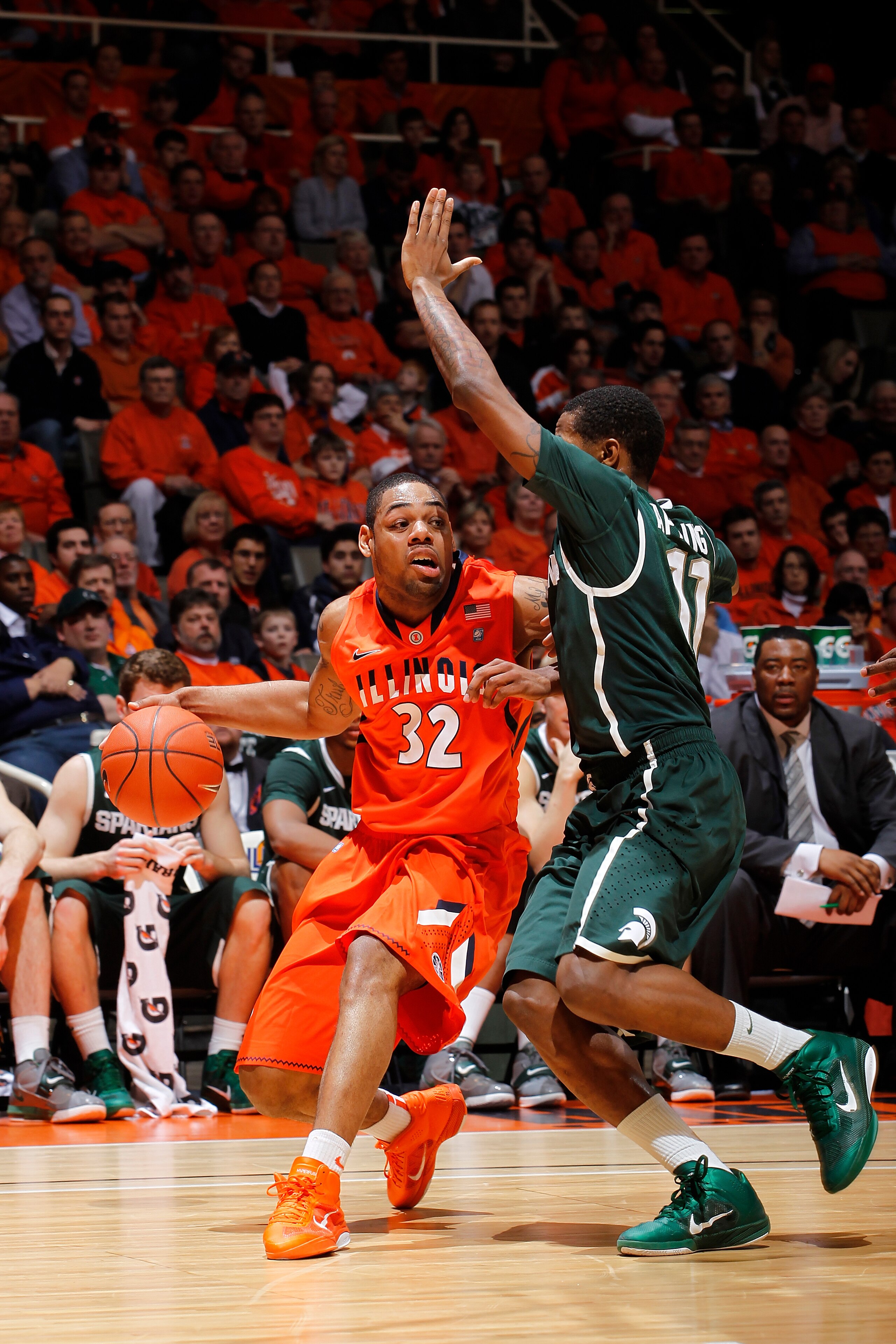 CHAMPAIGN, IL - JANUARY 18: Demetri McCamey #32 of the Illinois Fighting Illini tries to get to the basket against Keith Appling #11 of the Michigan State Spartans in the first half at Assembly Hall on January 18, 2011 in Champaign, Illinois. (Photo by Jo