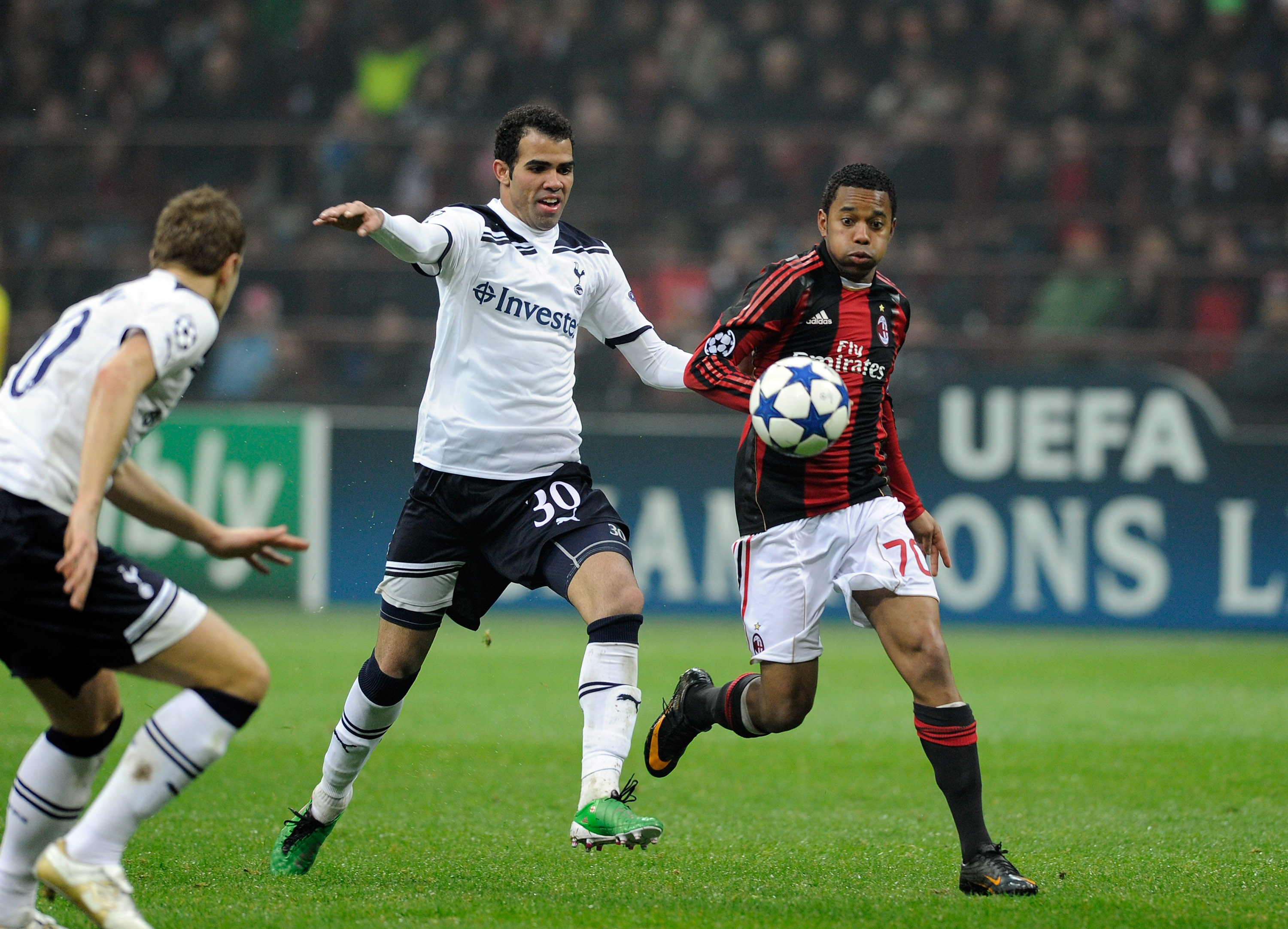 MILAN, ITALY - FEBRUARY 15:  Robinho of AC Milan and Sandro of Tottenham Hotspur during the UEFA Champions League round of 16 first leg match between AC Milan and Tottenham Hotspur at Stadio Giuseppe Meazza on February 15, 2011 in Milan, Italy.  (Photo by