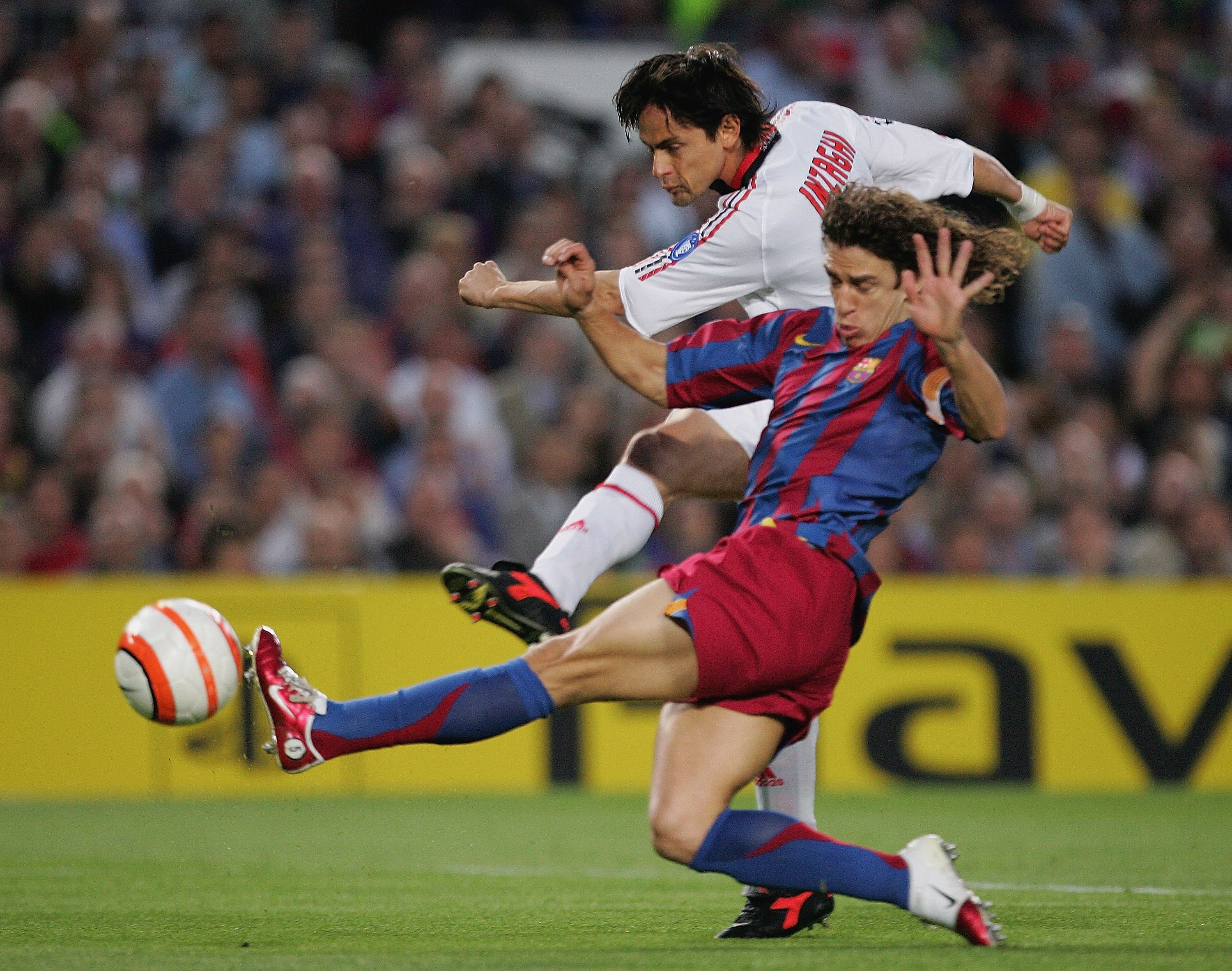 BARCELONA, SPAIN - APRIL 26: Filippo Inzaghi of AC Miland shoots under pressure from Carles Puyol of Barcelona during the UEFA Champions League Semi Final match between Barcelona and AC Milan at the Camp Nou on April 26, 2006 in Barcelona, Spain.   (Photo