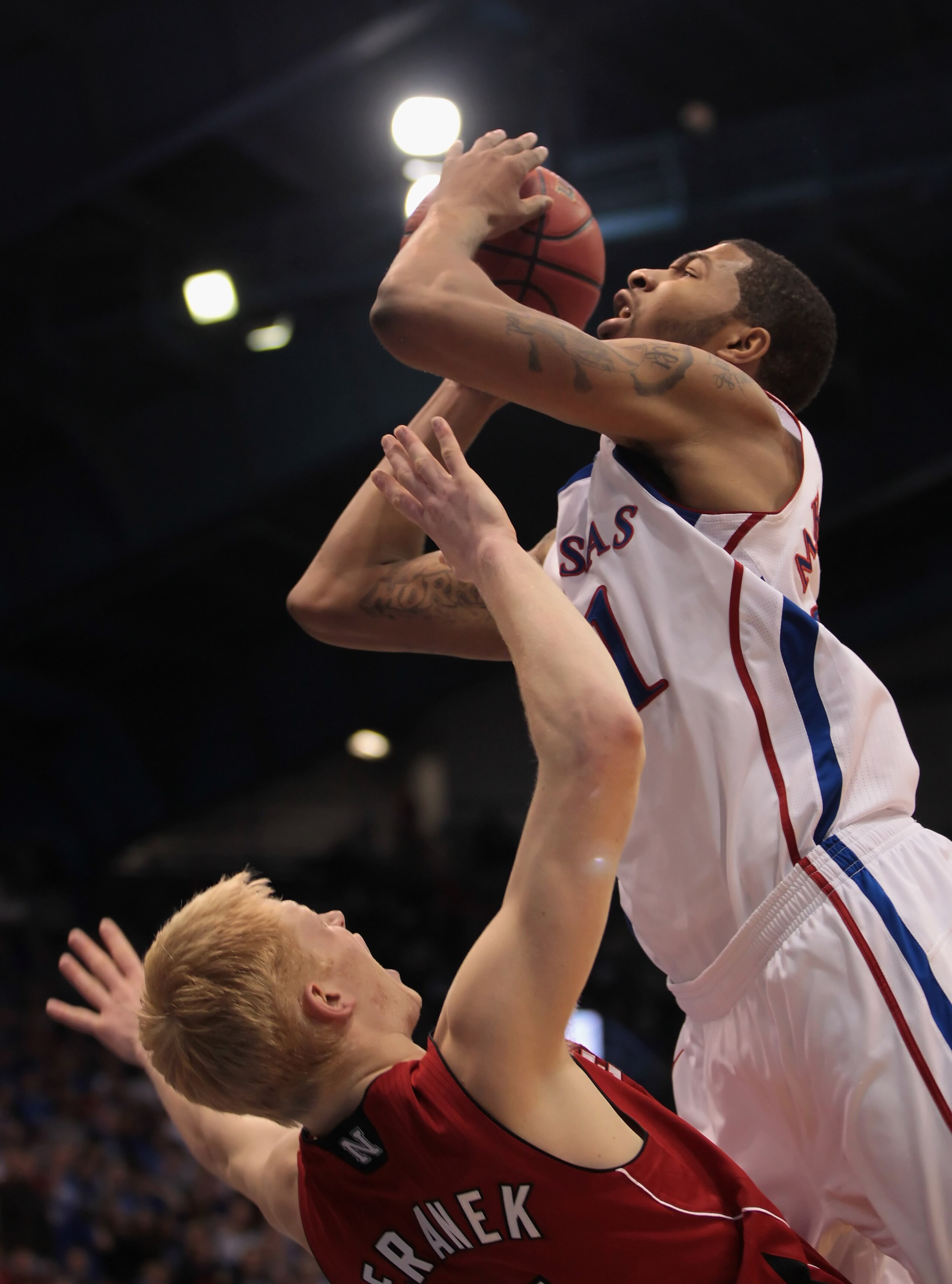 LAWRENCE, KS - JANUARY 15:  Markieff Morris #21 of the Kansas Jayhawks is fouled by Drake Beranek #31 of the Nebraska Cornhuskers during the game on January 15, 2011 at Allen Fieldhouse in Lawrence, Kansas.  (Photo by Jamie Squire/Getty Images)