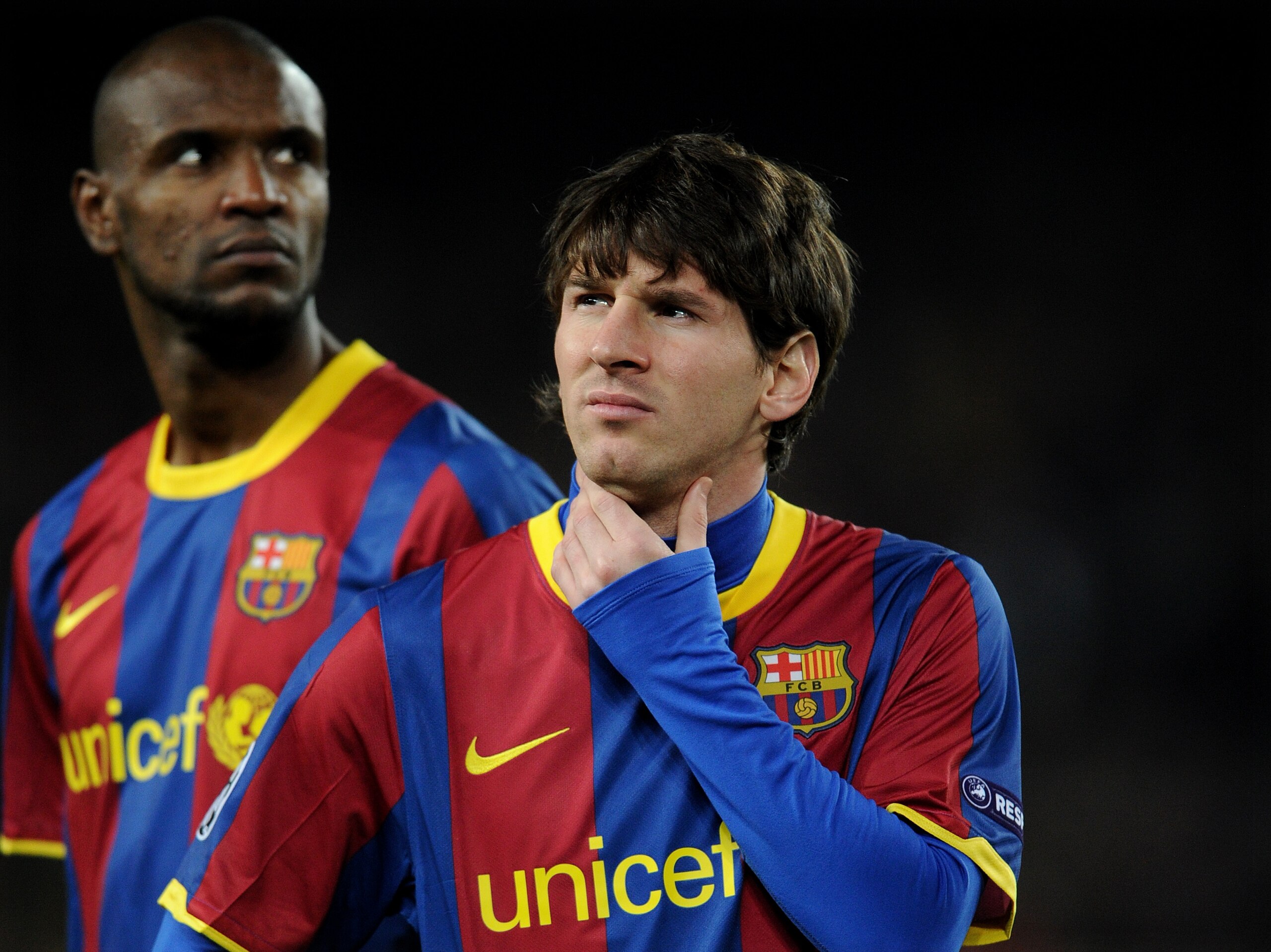 BARCELONA, SPAIN - MARCH 08:  Lionel Messi (R) of Barcelona stands besides his teammate Eric Abidal prior to the start of the UEFA Champions League round of 16 second leg match between Barcelona and Arsenal on March 8, 2011 in Barcelona, Spain.  (Photo by