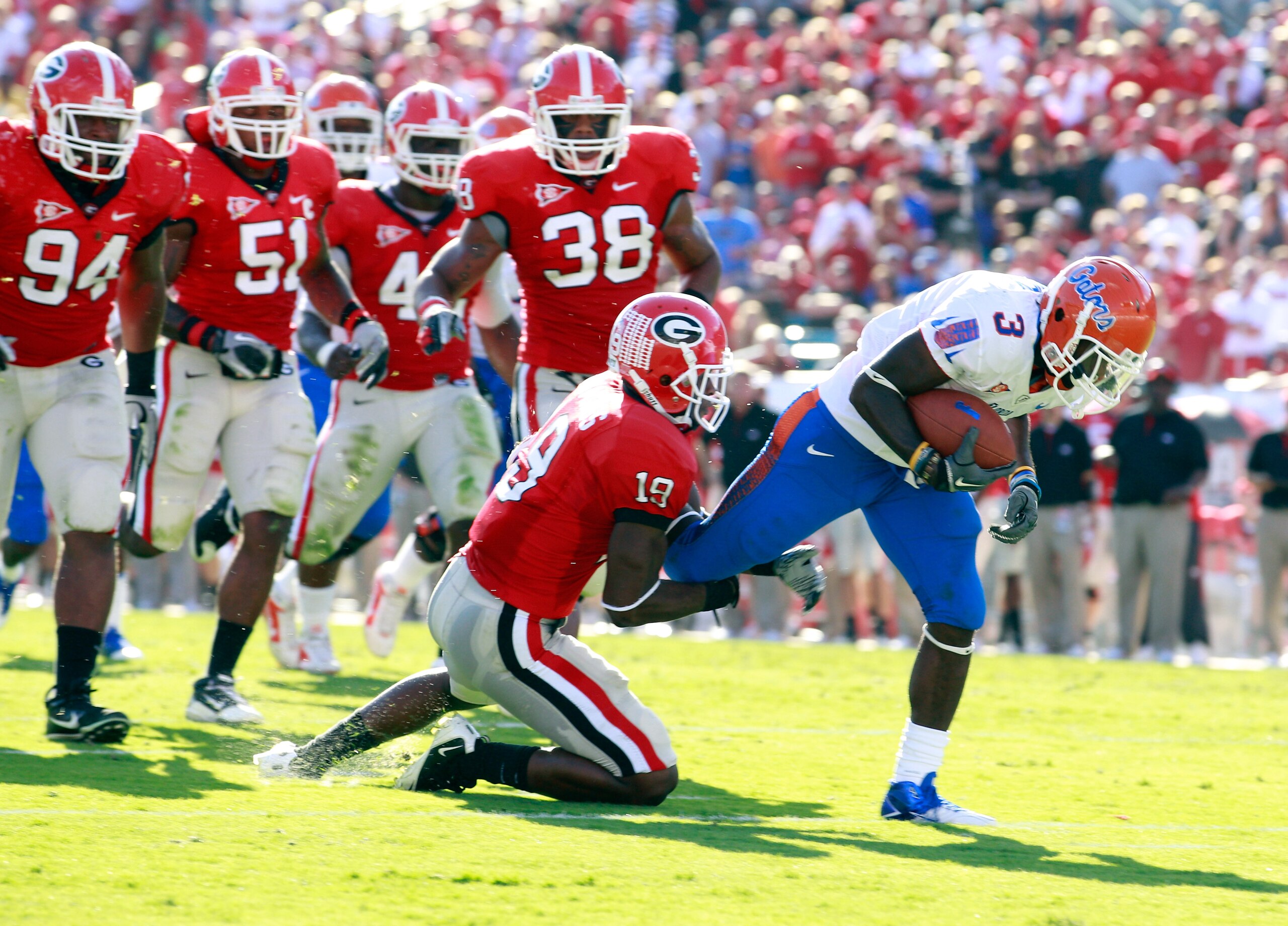 JACKSONVILLE, FL - OCTOBER 30:  Chris Rainey #3 of the Florida Gators attempts to break the tackle of Sanders Commings #19 of the Georgia Bulldogs during the game at EverBank Field on October 30, 2010 in Jacksonville, Florida.  (Photo by Sam Greenwood/Get