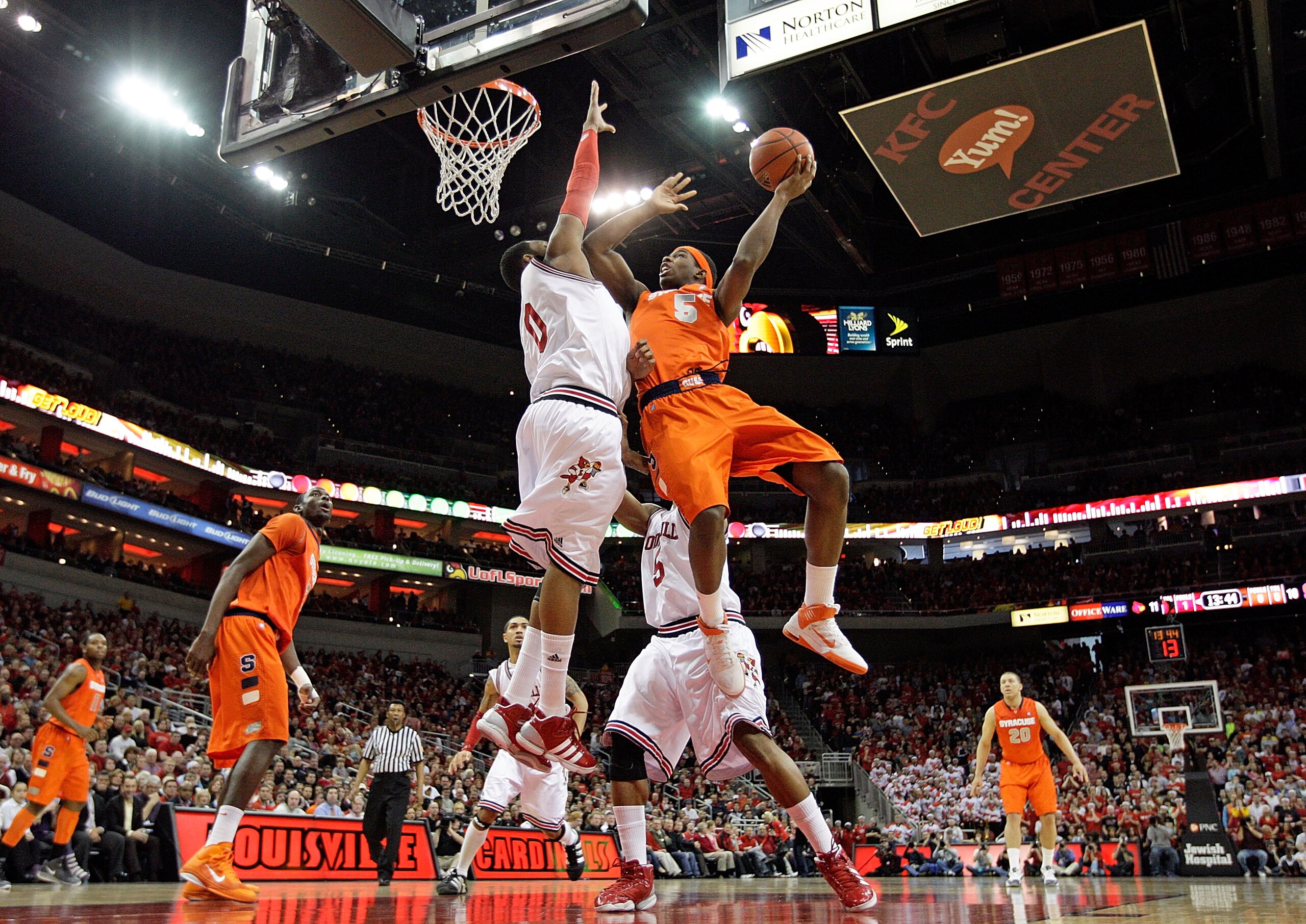 LOUISVILLE, KY - FEBRUARY 12:  George Goode #0 of the Louisville Cardinals defends the shot of C.J. Fair #5 of the Syracuse Orange during the Big East Conference game against  at the KFC Yum! Center on February 12, 2011 in Louisville, Kentucky.  (Photo by