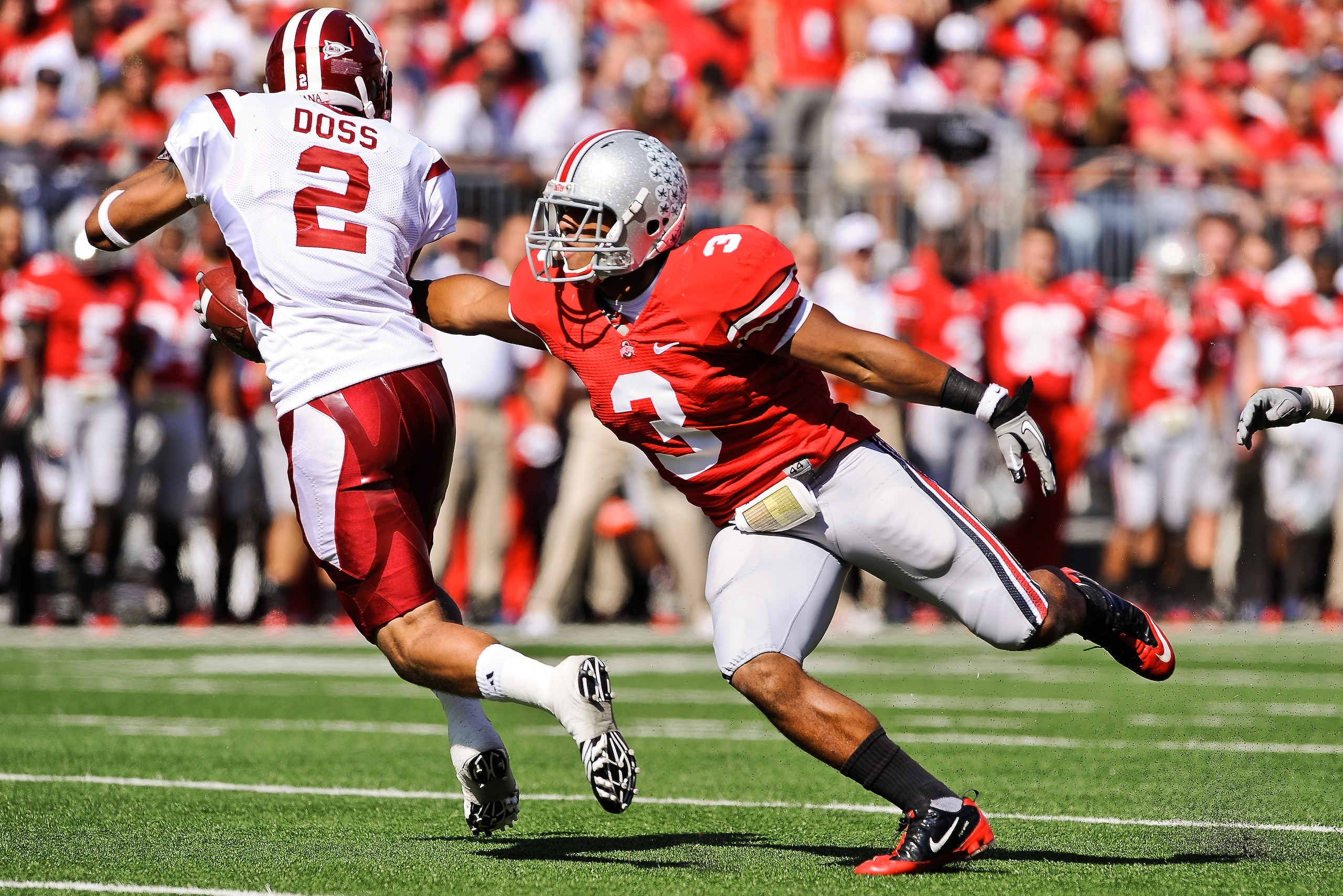 COLUMBUS, OH - OCTOBER 9:  Brandon Saine #3 of the Ohio State Buckeyes attempts to make a tackle on Tandon Doss #2 of the Indiana Hoosiers during a kickoff return at Ohio Stadium on October 9, 2010 in Columbus, Ohio.  (Photo by Jamie Sabau/Getty Images)