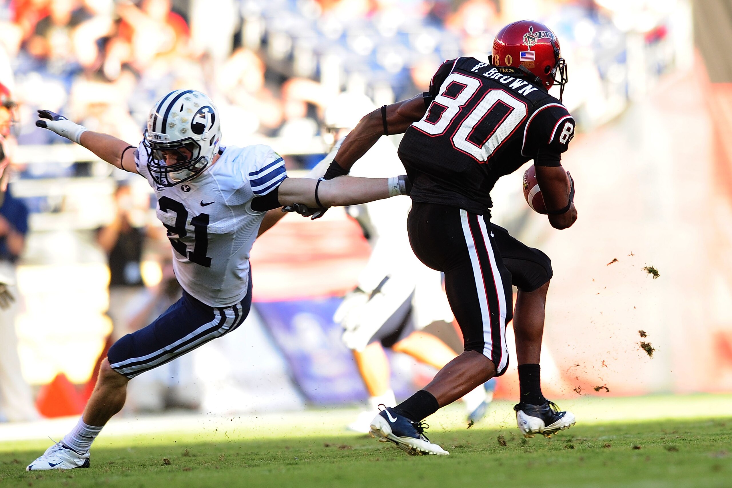 SAN DIEGO - OCTOBER 17:  Tyler Holt #31 of BYU Cougars tries to stop Vincent Brown #80 of San Diego State Aztecs at Qualcomm Stadium on October 17, 2009 in San Diego, California. BYU Cougars defeated the Aztecs 38-28  (Photo by Jacob de Golish/Getty Image