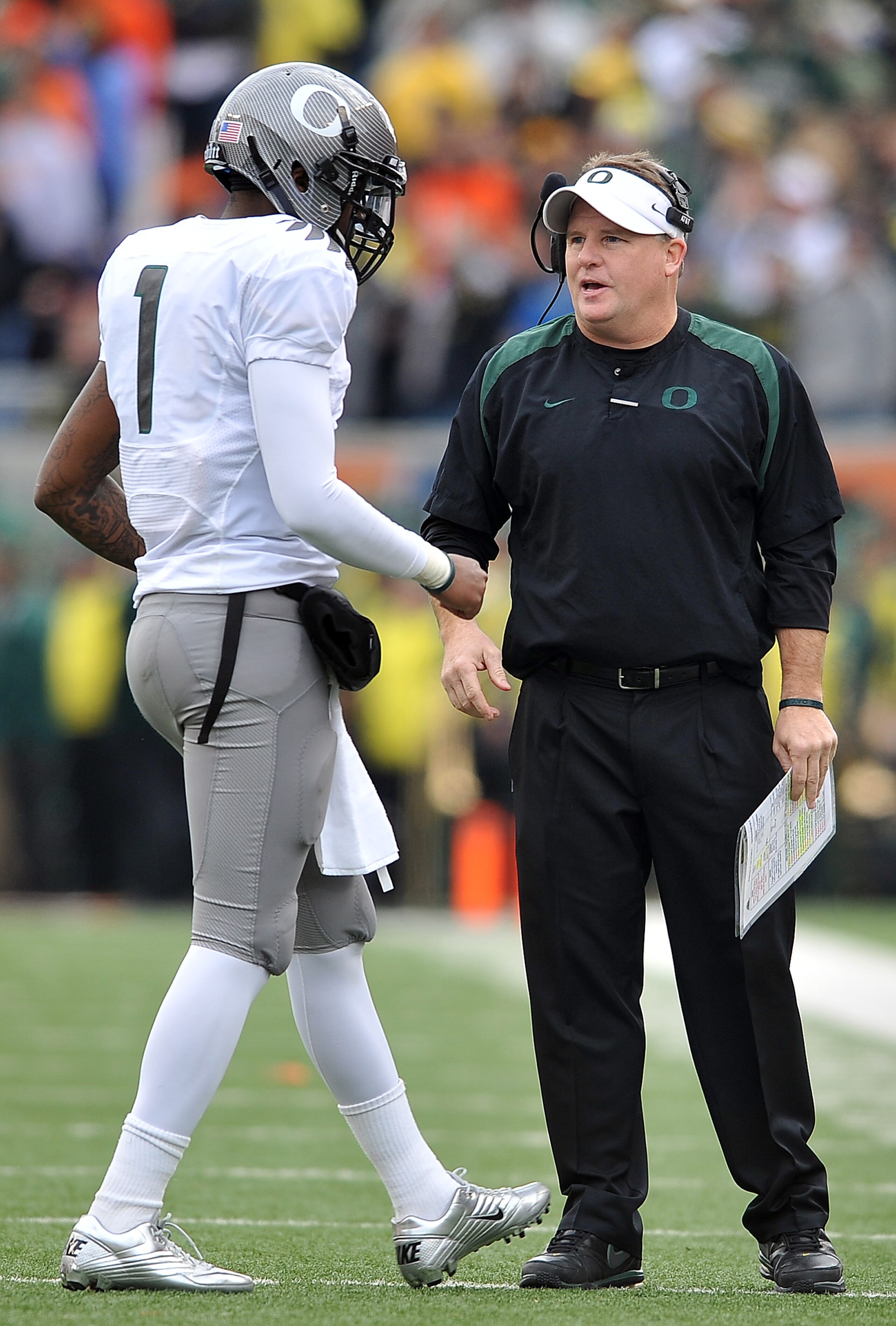CORVALLIS, OR - DECEMBER 4: Head coach Chip Kelly speaks with quarterback Darron Thomas #1 of the Oregon Ducks in the second quarter of the game against the the Oregon State Beavers at Reser Stadium on December 4, 2010 in Corvallis, Oregon. The Ducks beat